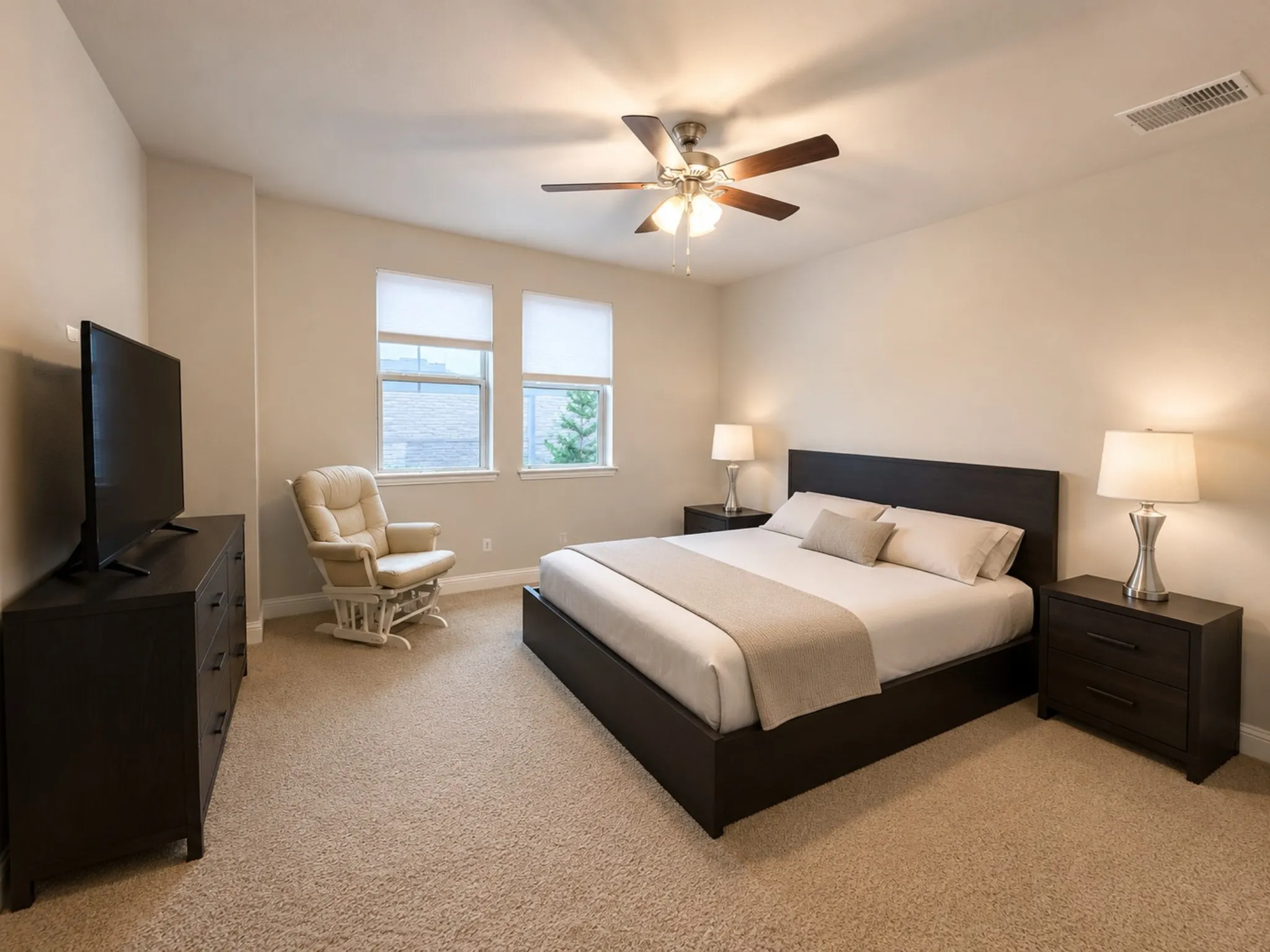 Carpeted room featuring two windows with blinds, a ceiling fan with integrated lighting, and neutral wall tones