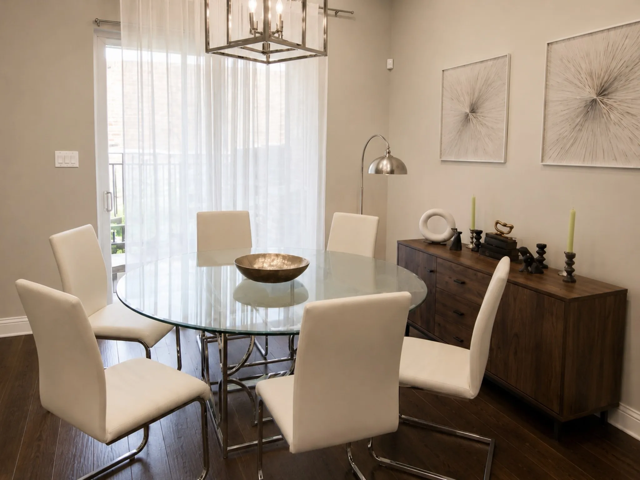 Dining area featuring wood-finish flooring, a contemporary chandelier, and a sliding glass door