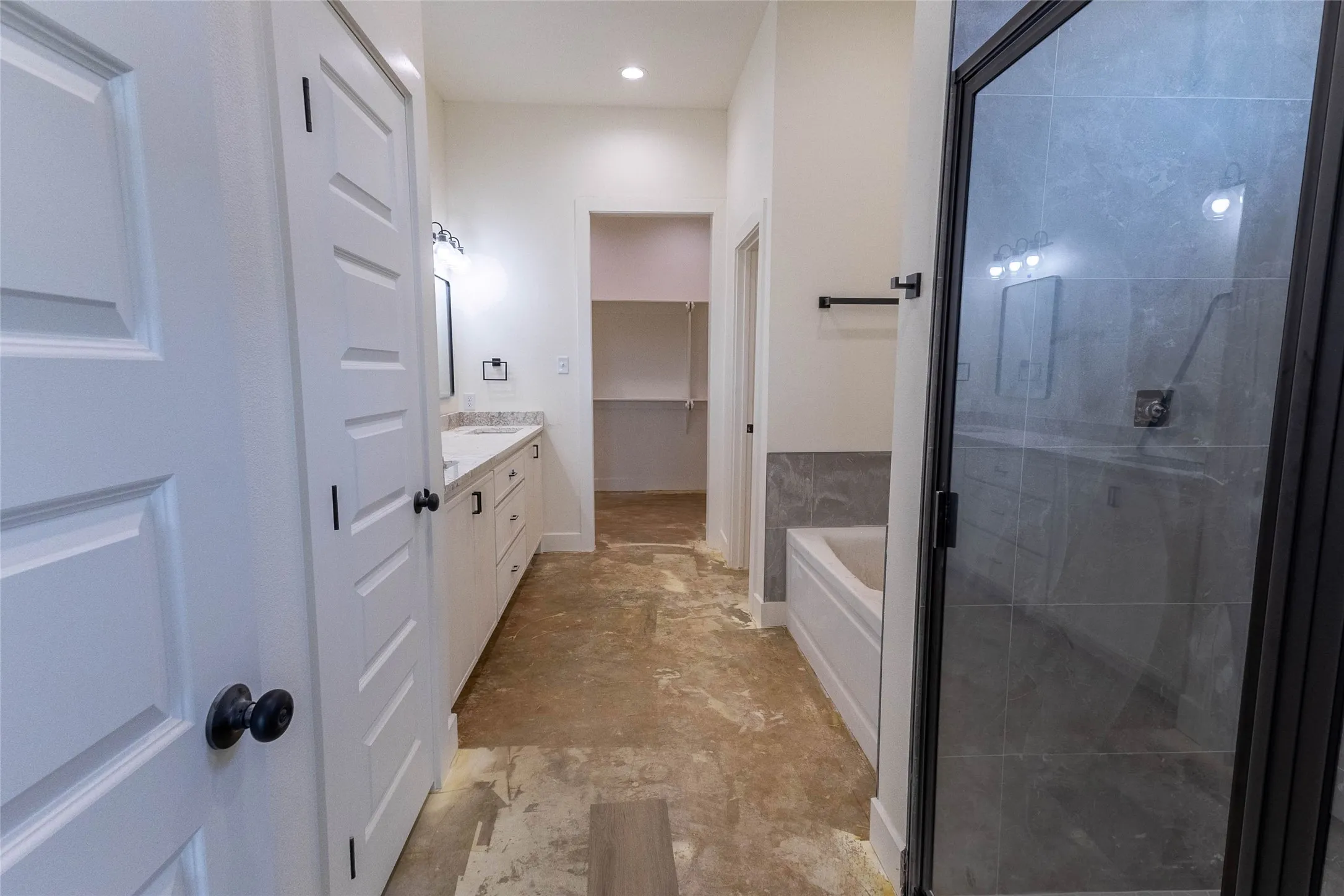 Double vanity with white cabinetry and light-toned countertop