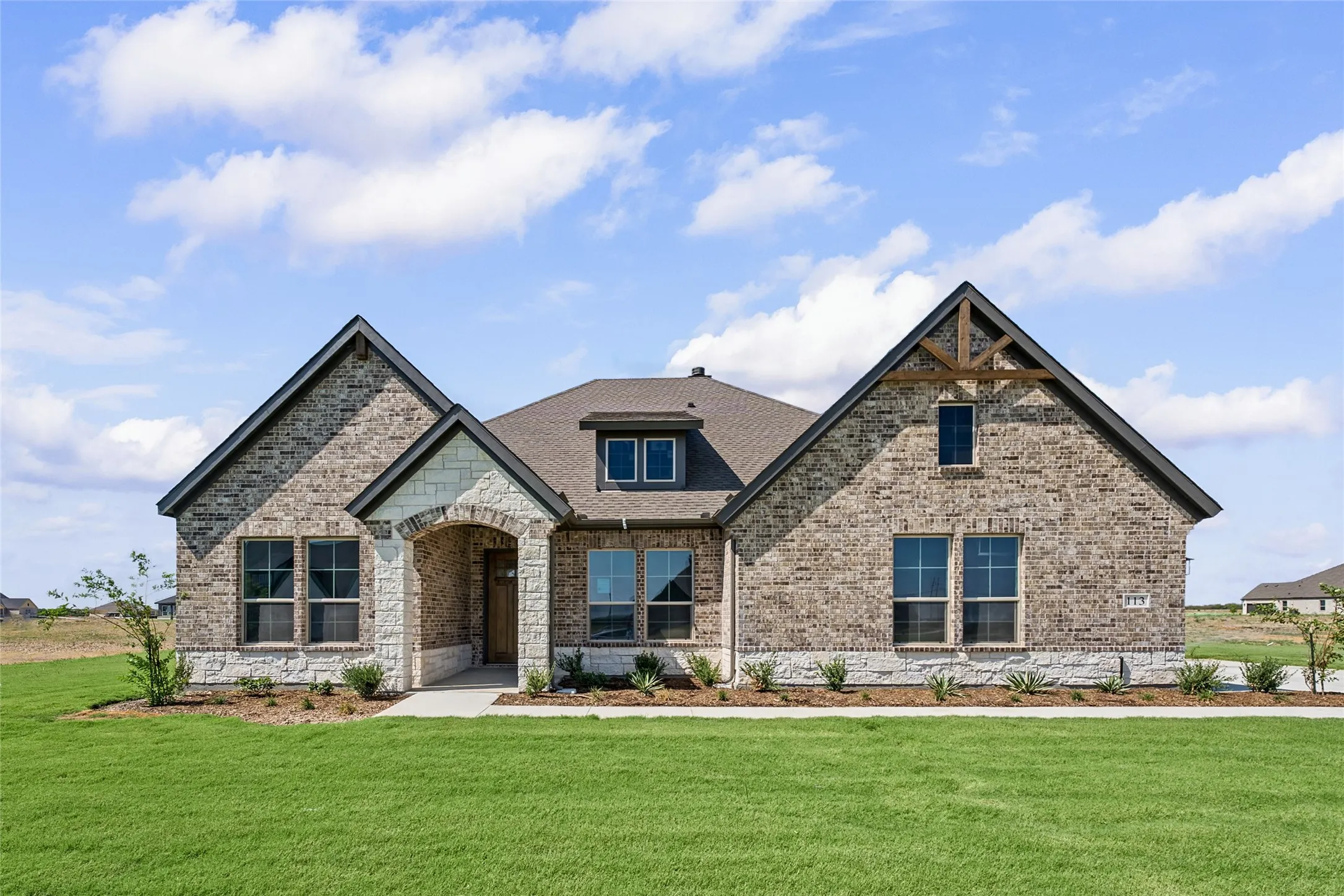 Brick and stone façade with gabled rooflines