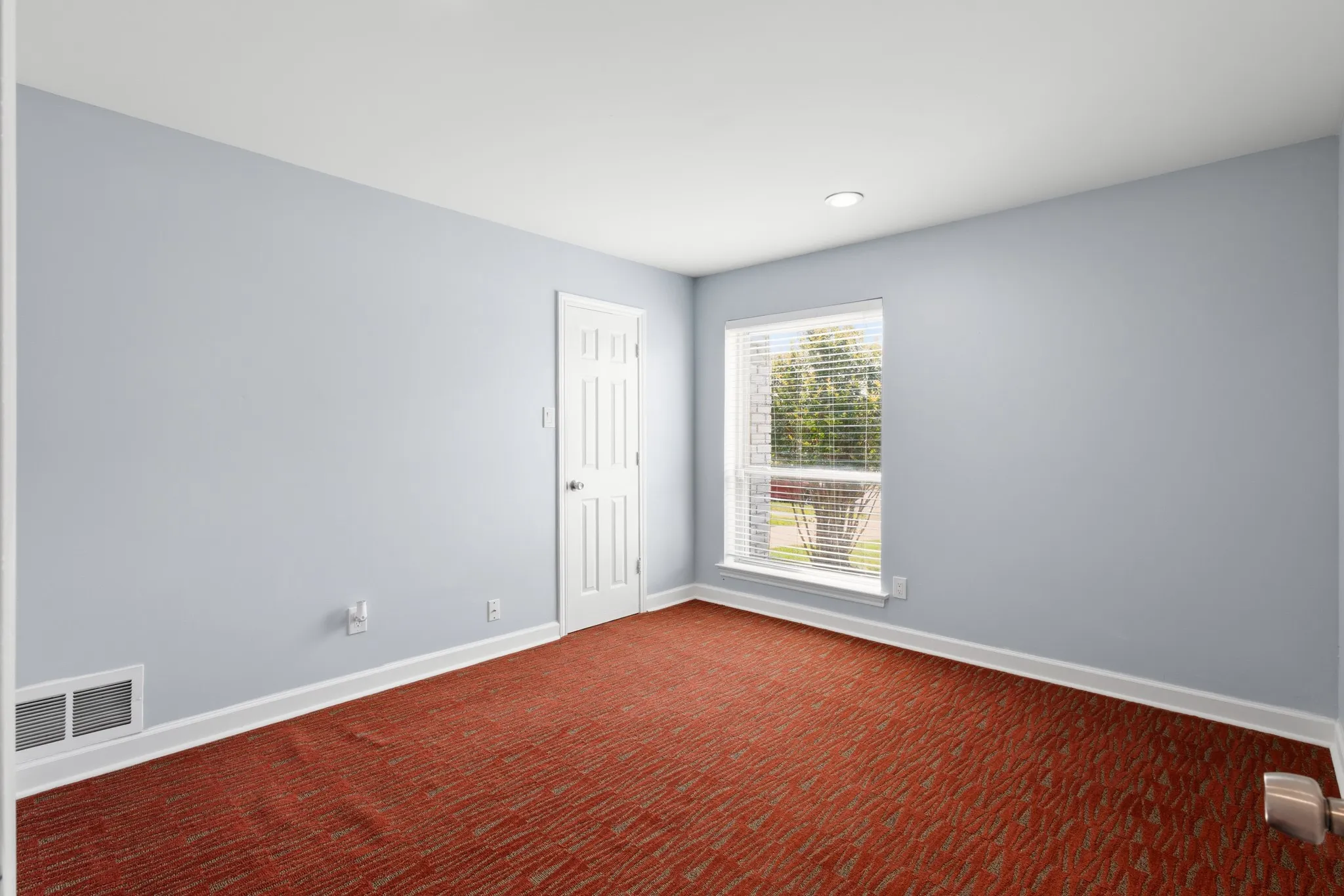 Walk-in closet featuring white built-in shelving, hanging rods, and dark wood-finish flooring