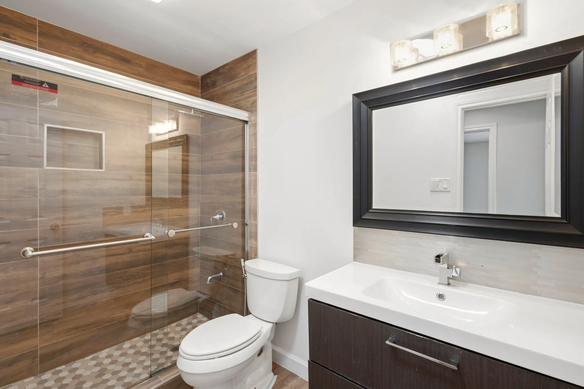 Powder room featuring a white vanity with a rectangular sink, a polished chrome faucet, and a light-colored countertop