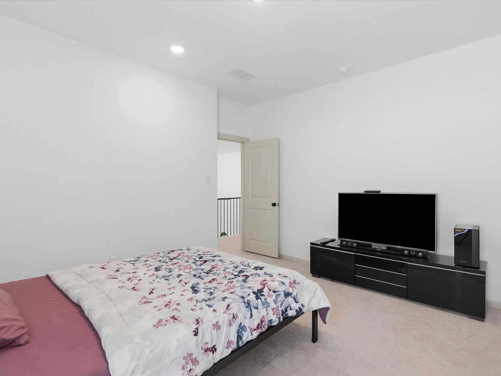 Room with light-colored carpeting and white wall finishes