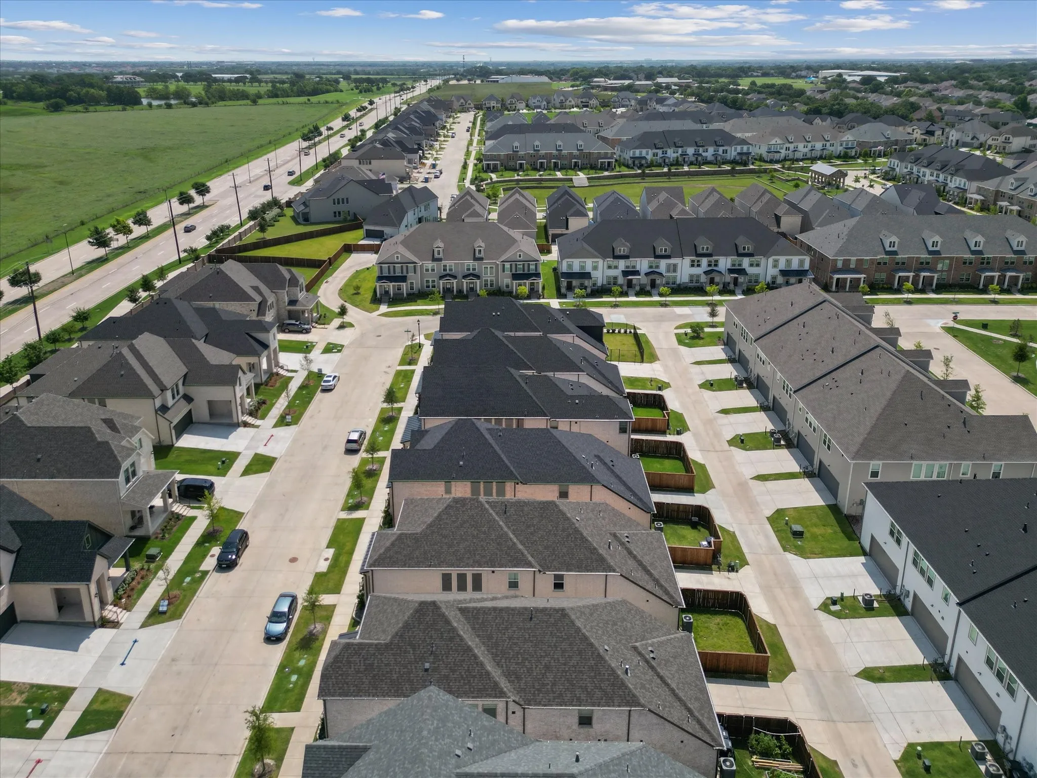 Aerial perspective showcasing a residential development with multiple detached and attached housing units