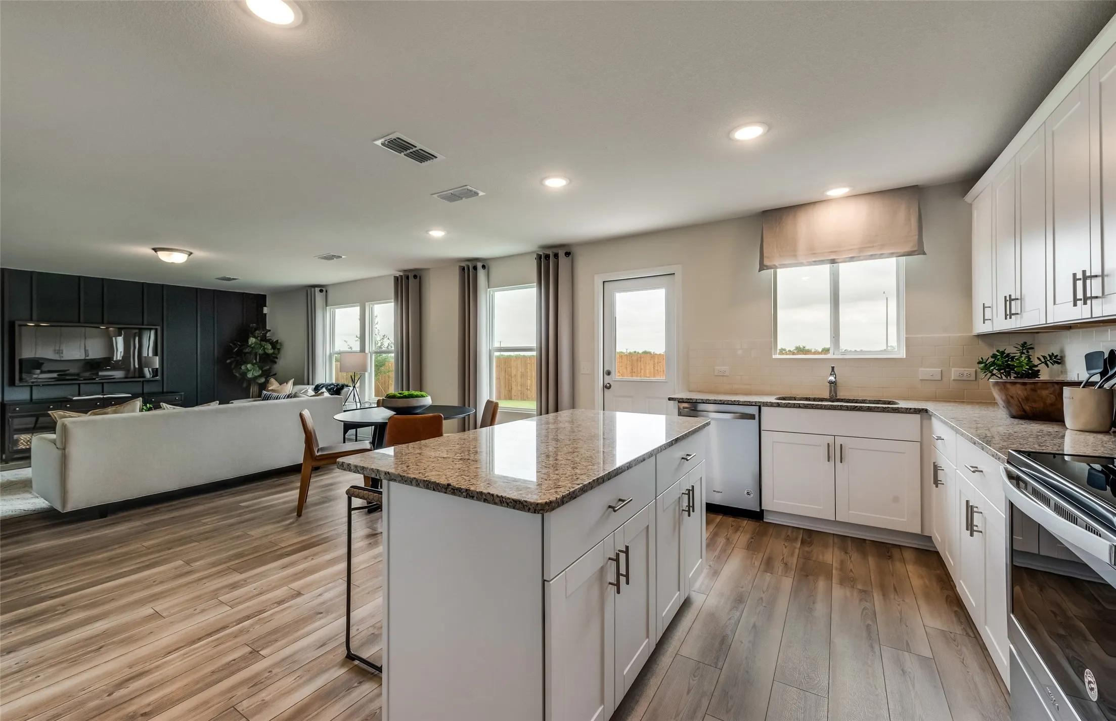 *Model Representation - Large island overlooking gathering room and dining areas