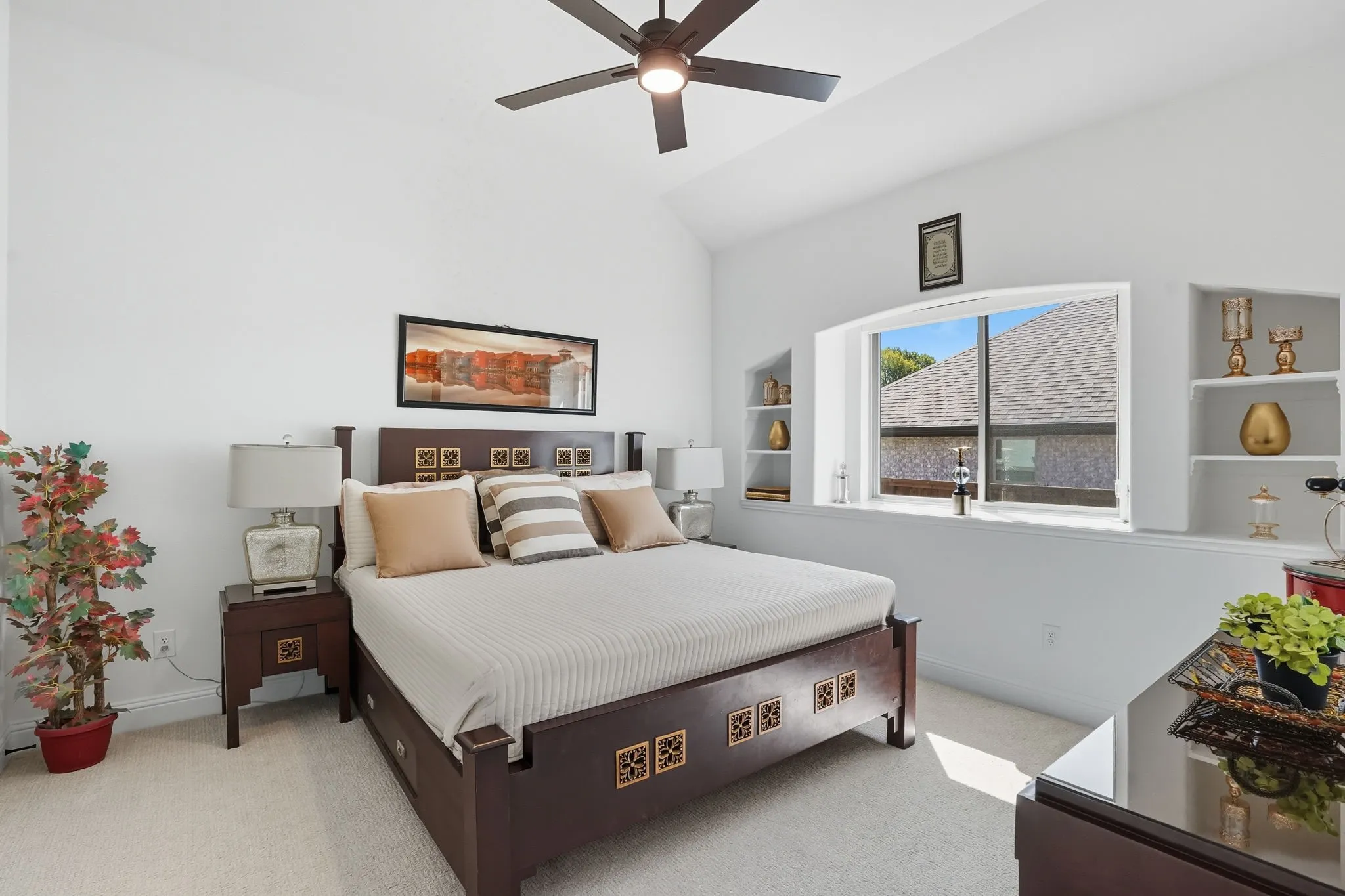 Spacious room featuring a vaulted ceiling and a ceiling fan