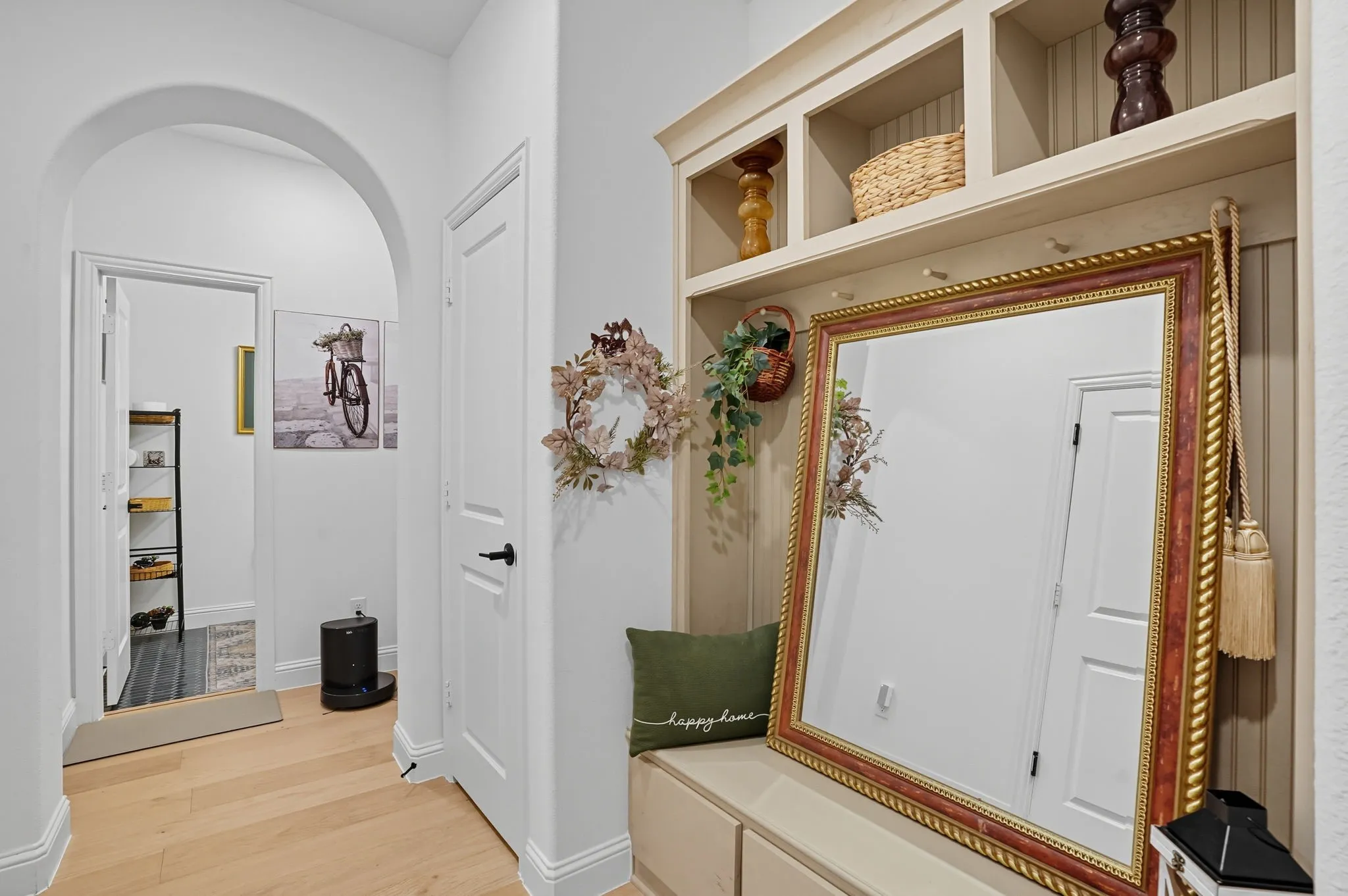 Built-in entryway storage with shelving and bench seating, featuring beadboard paneling
