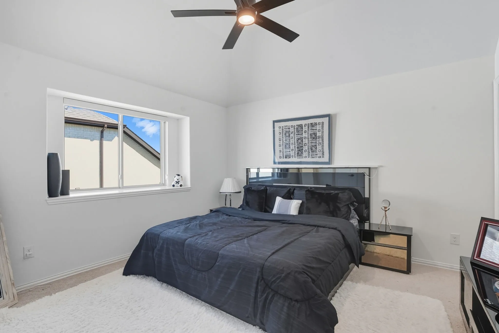 Vaulted ceiling featuring a ceiling fan with integrated lighting