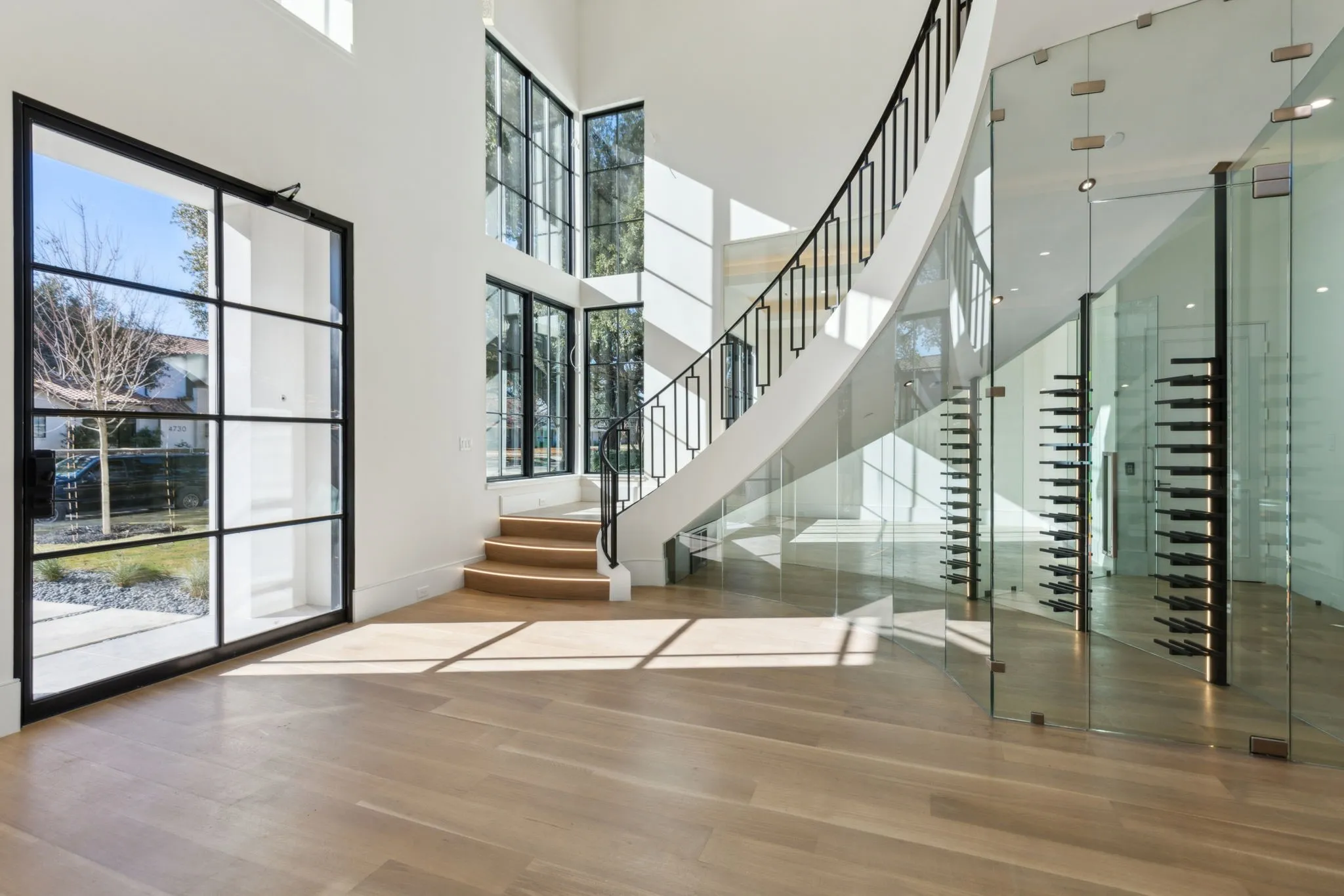 Wine area with a high ceiling and wood finished floors