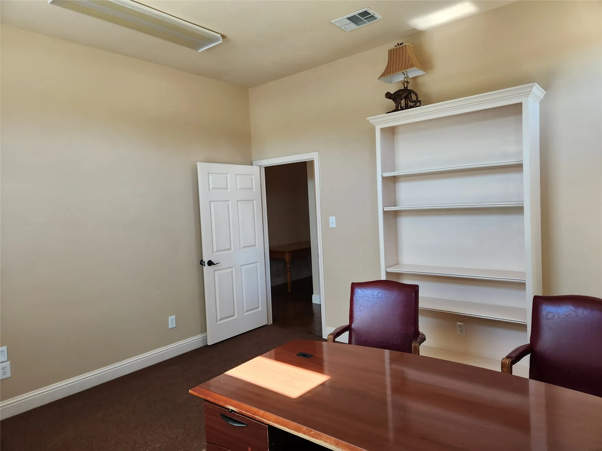 Built-in shelving unit with crown molding, presenting display and storage capabilities