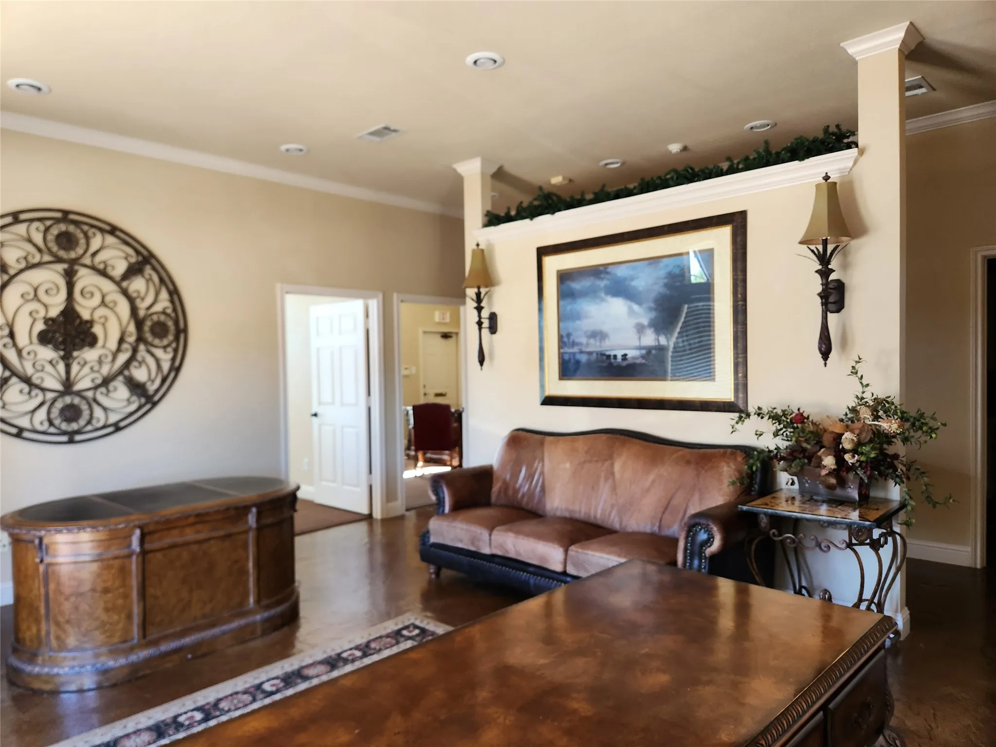 Recessed lighting illuminates a spacious room featuring crown molding and wood-finish flooring