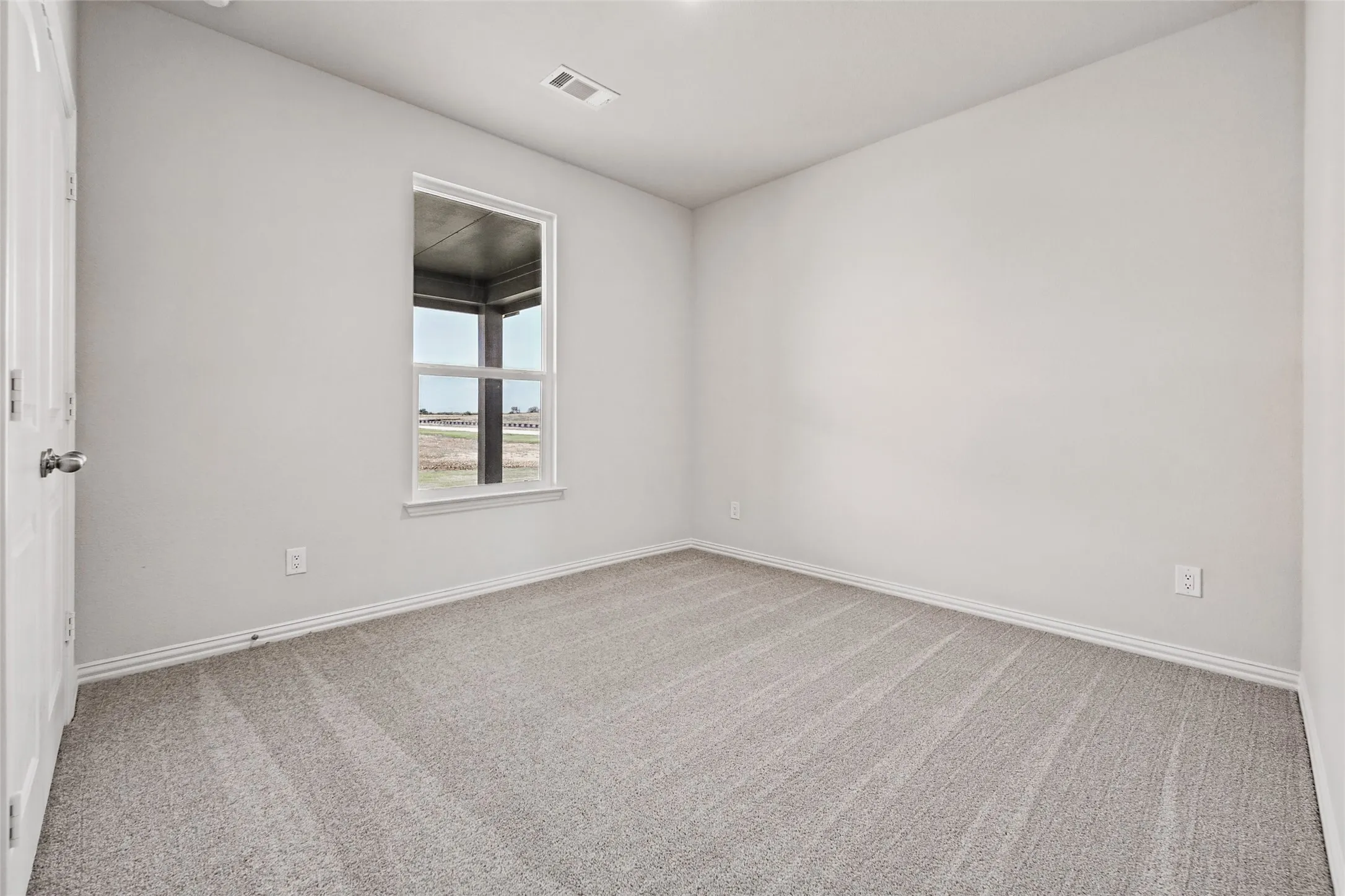 Carpeted flooring, single window, white wall paint, white trim, white door