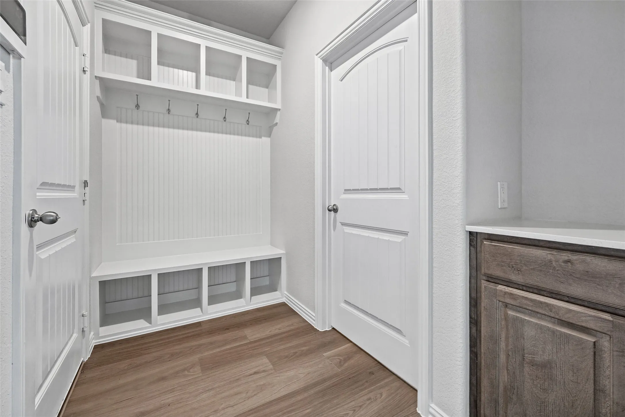 Built-in hall tree with beadboard detailing, upper cubbies, and lower storage compartments