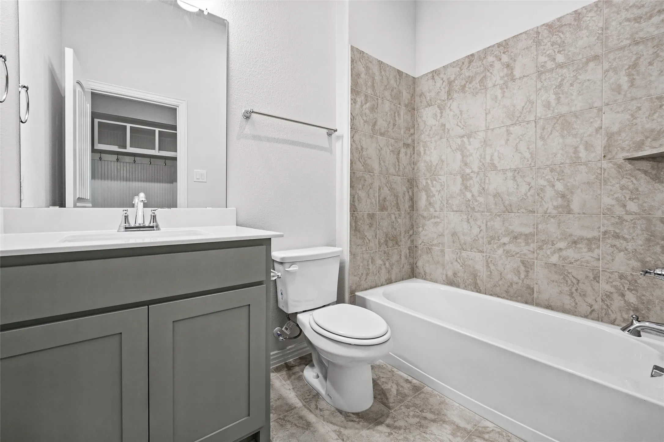Vanity with integrated sink, chrome faucet, and rectangular mirror