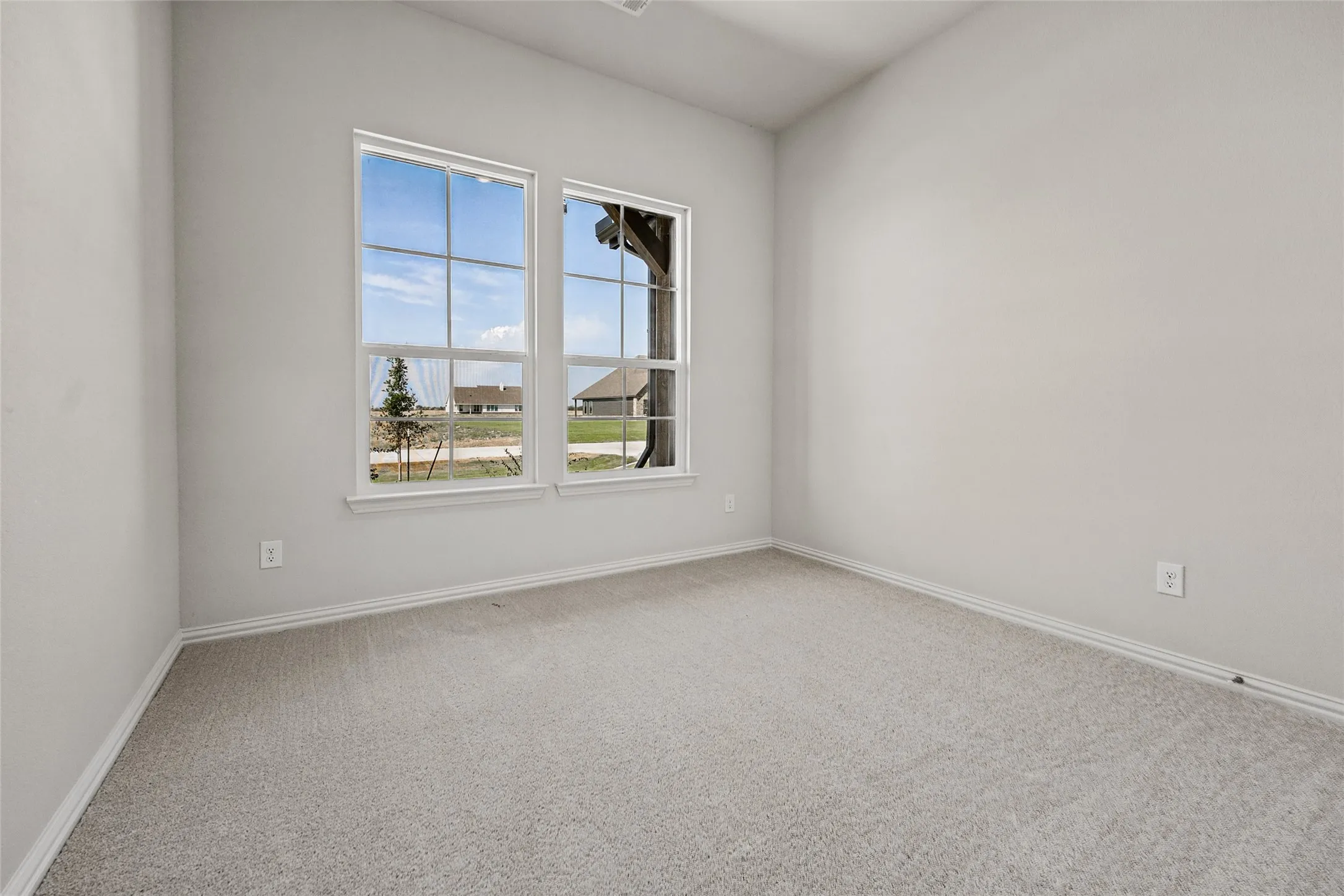 Wall-to-wall carpeting, dual windows, and light-toned wall finishes