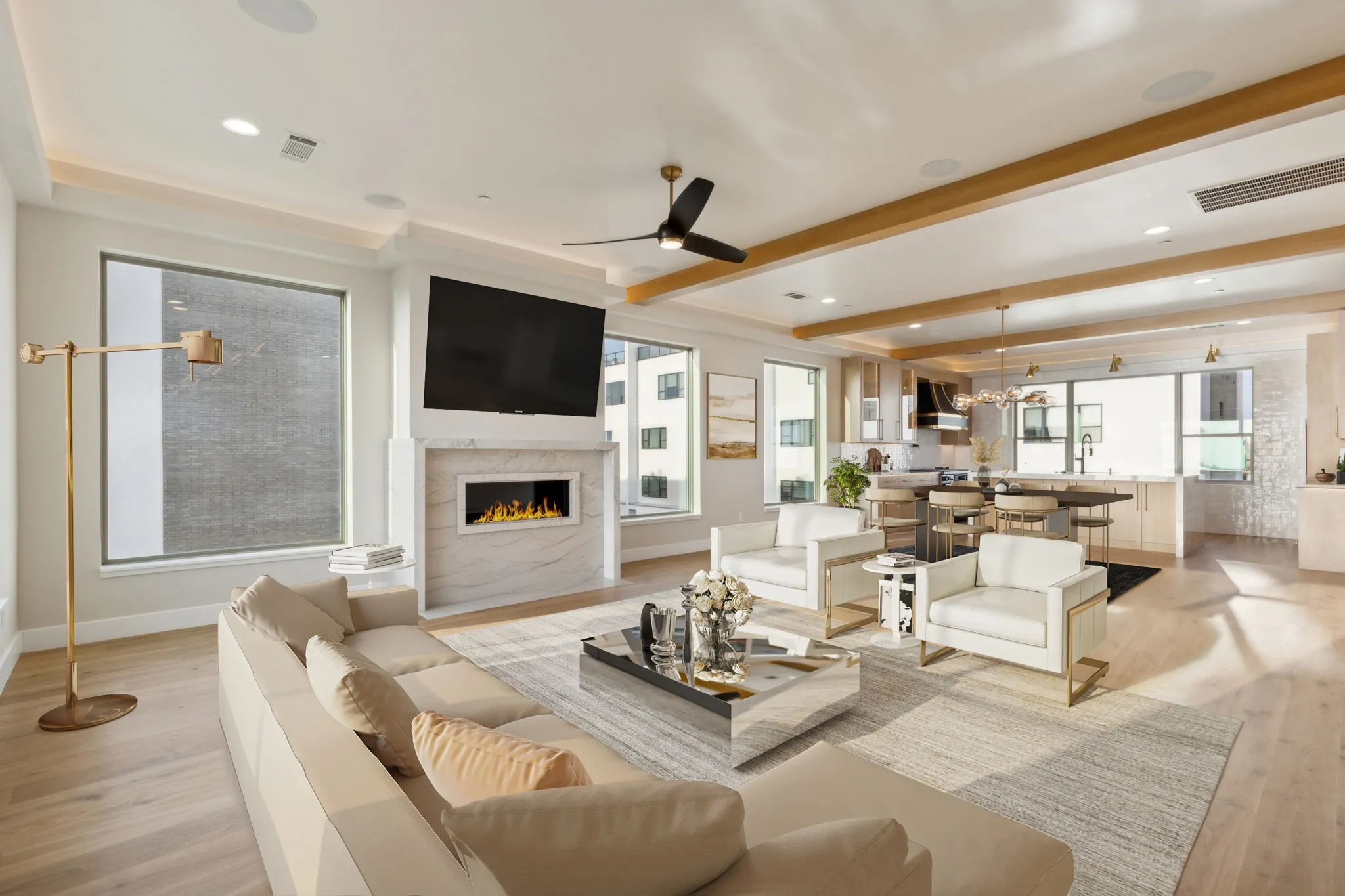 Living area featuring light wood finished floors, a lit fireplace, baseboards, beam ceiling, and a ceiling fan