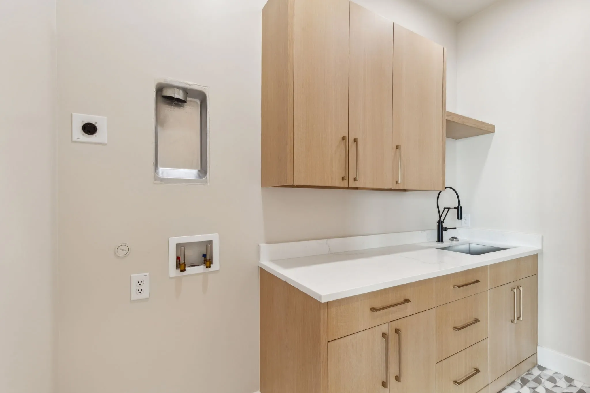 Washroom featuring hookup for an electric dryer, hookup for a washing machine, gas dryer hookup, baseboards, and cabinet space