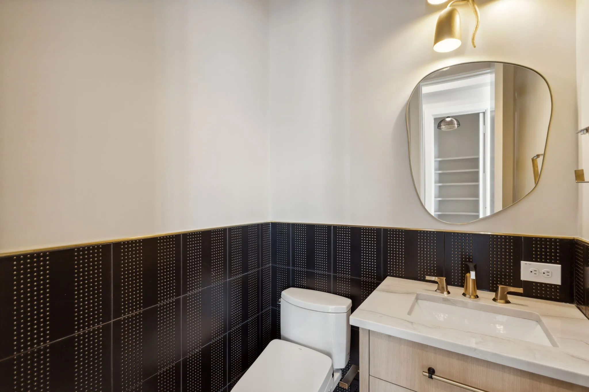 Bathroom with toilet, wainscoting, and vanity
