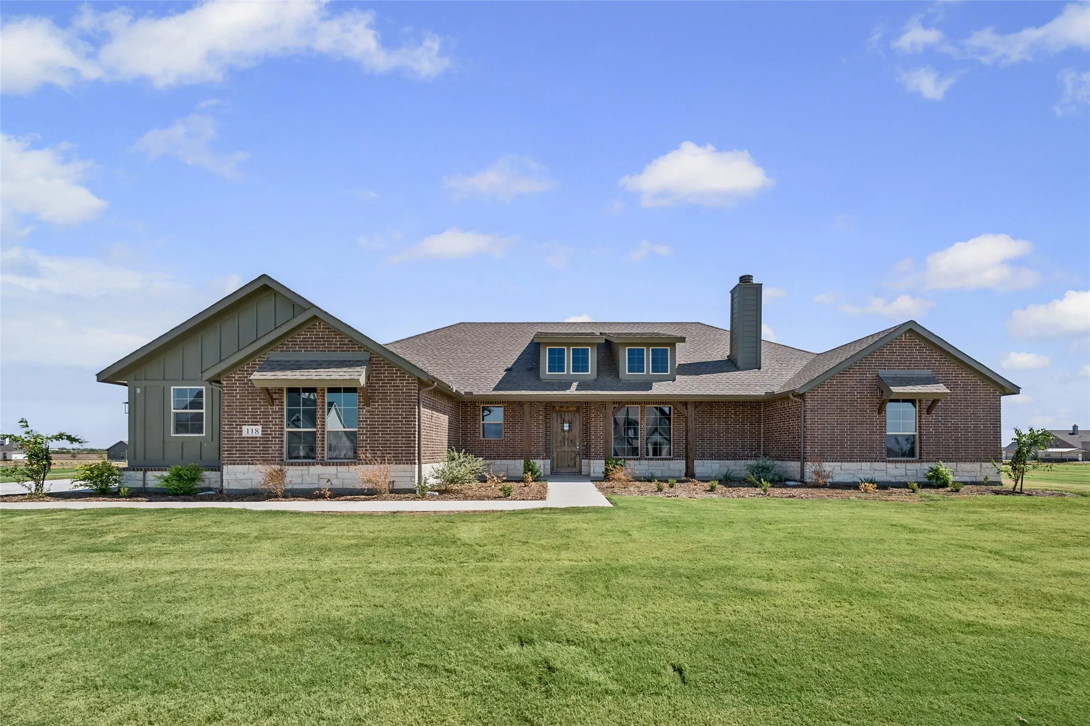 Brick and board-and-batten exterior with stone accents