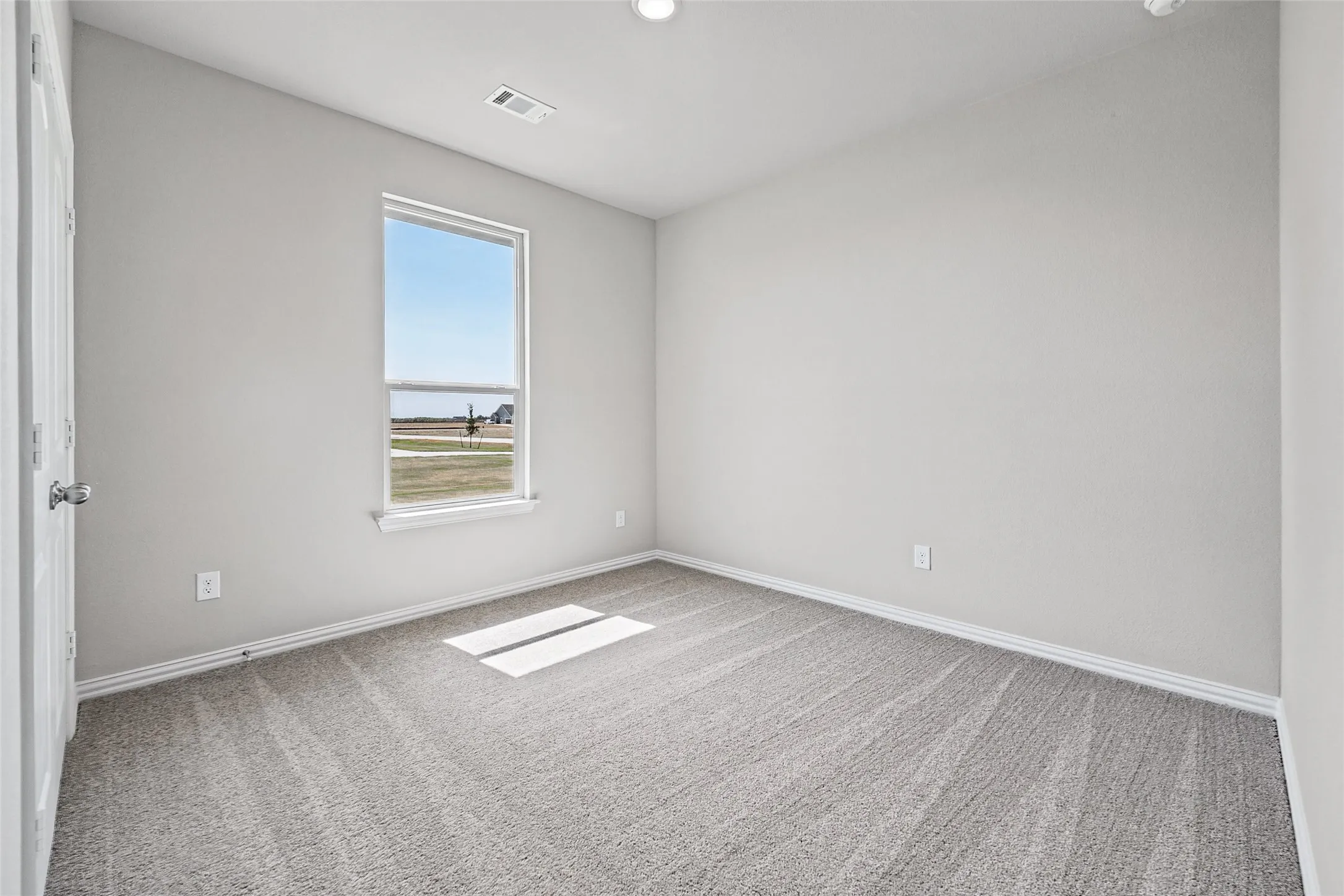 Neutral-toned walls complement the gray patterned carpet