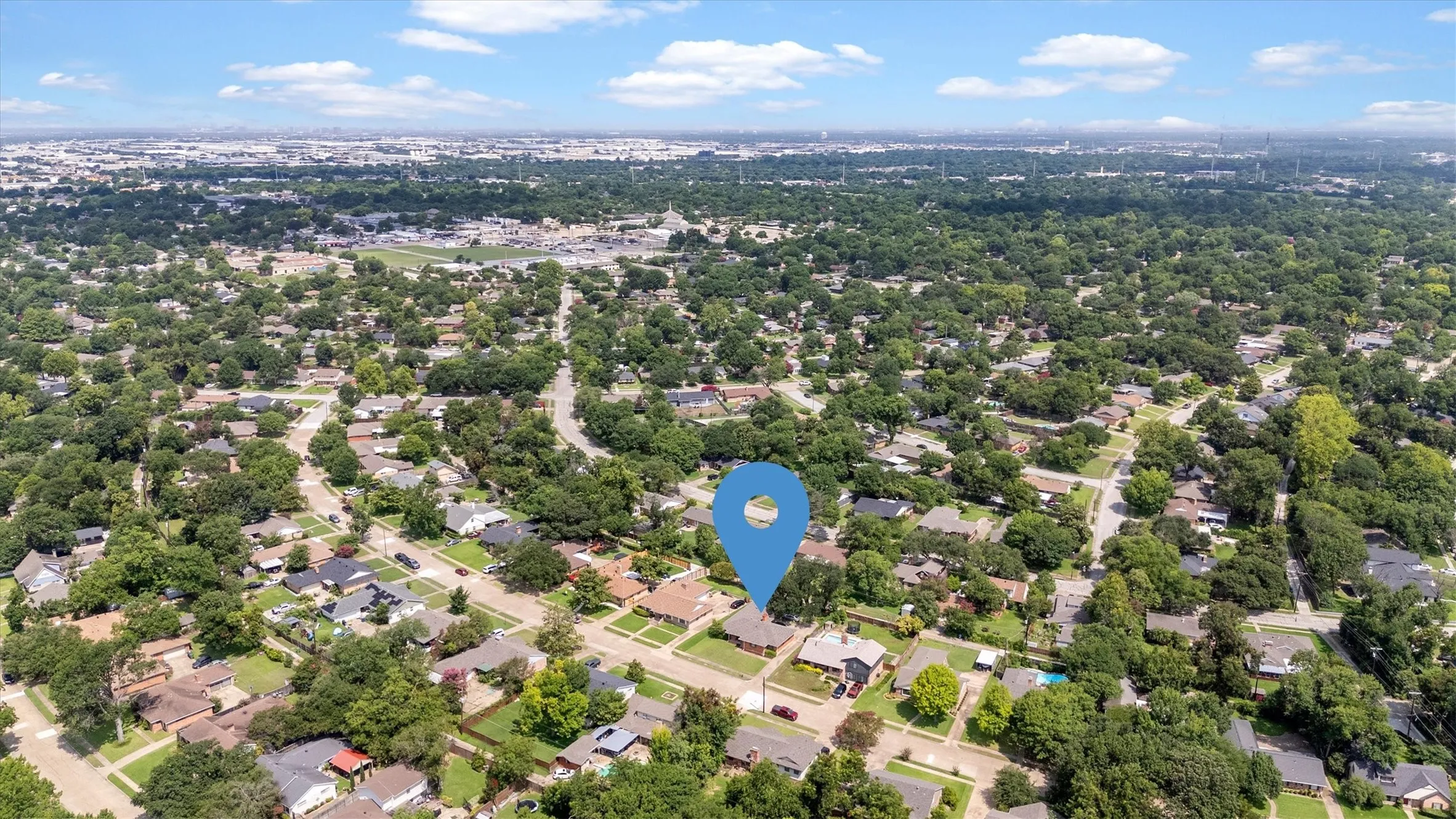 Suburban neighborhood with mature tree canopy and varied residential architecture