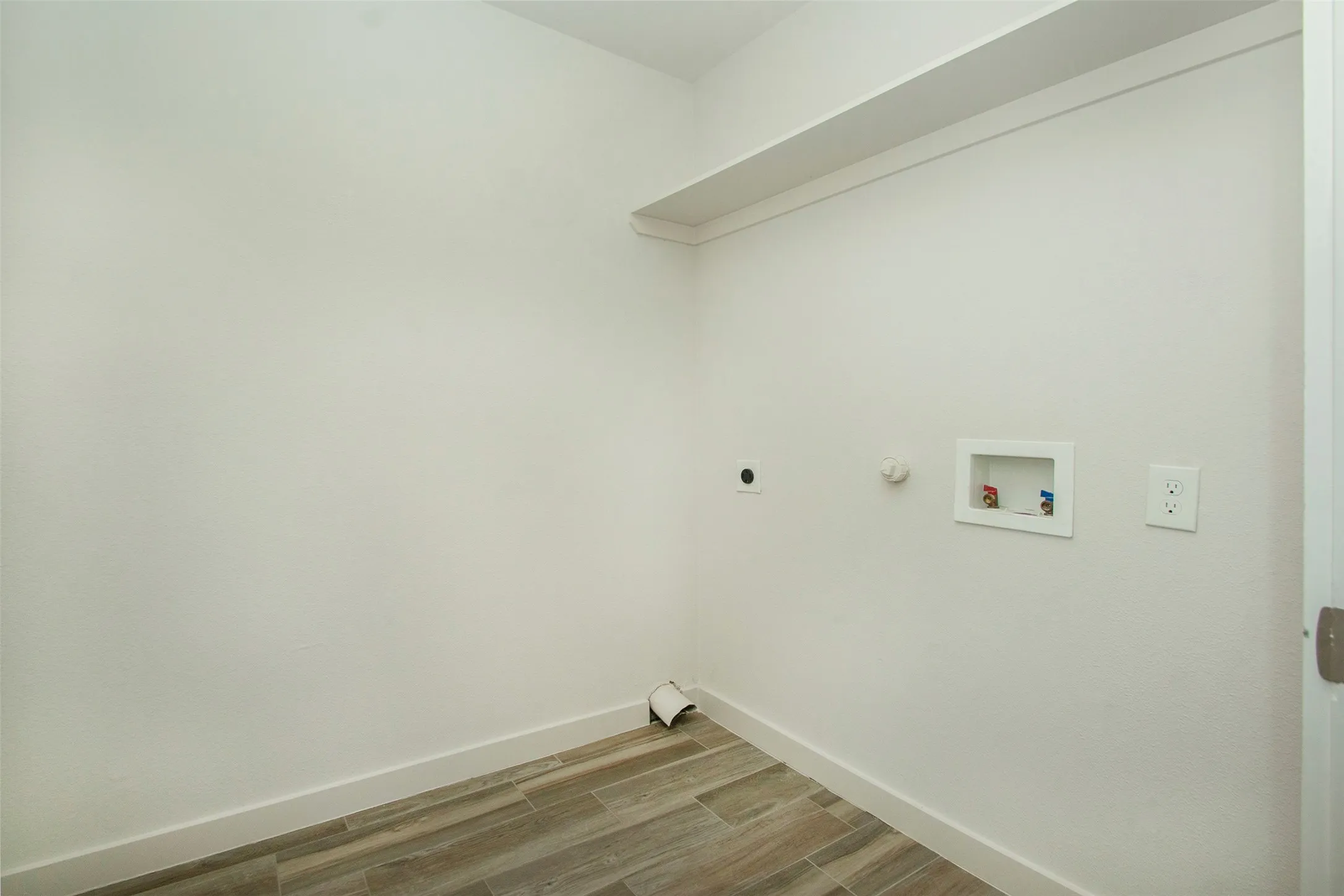 Clothes washing area featuring gas dryer hookup, hardwood / wood-style floors, hookup for a washing machine, and electric dryer hookup