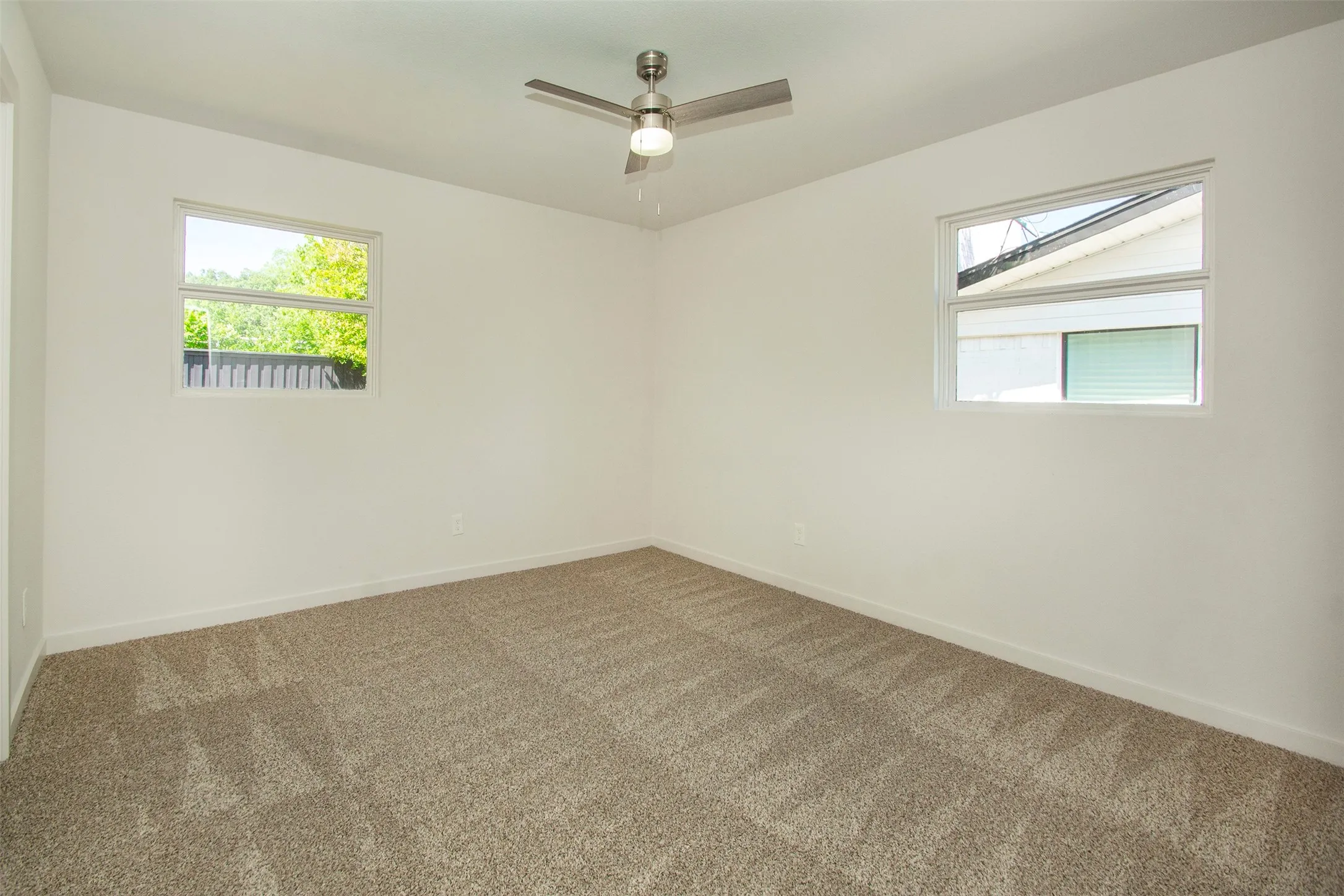 Bedroom featuring ceiling fan and carpet flooring