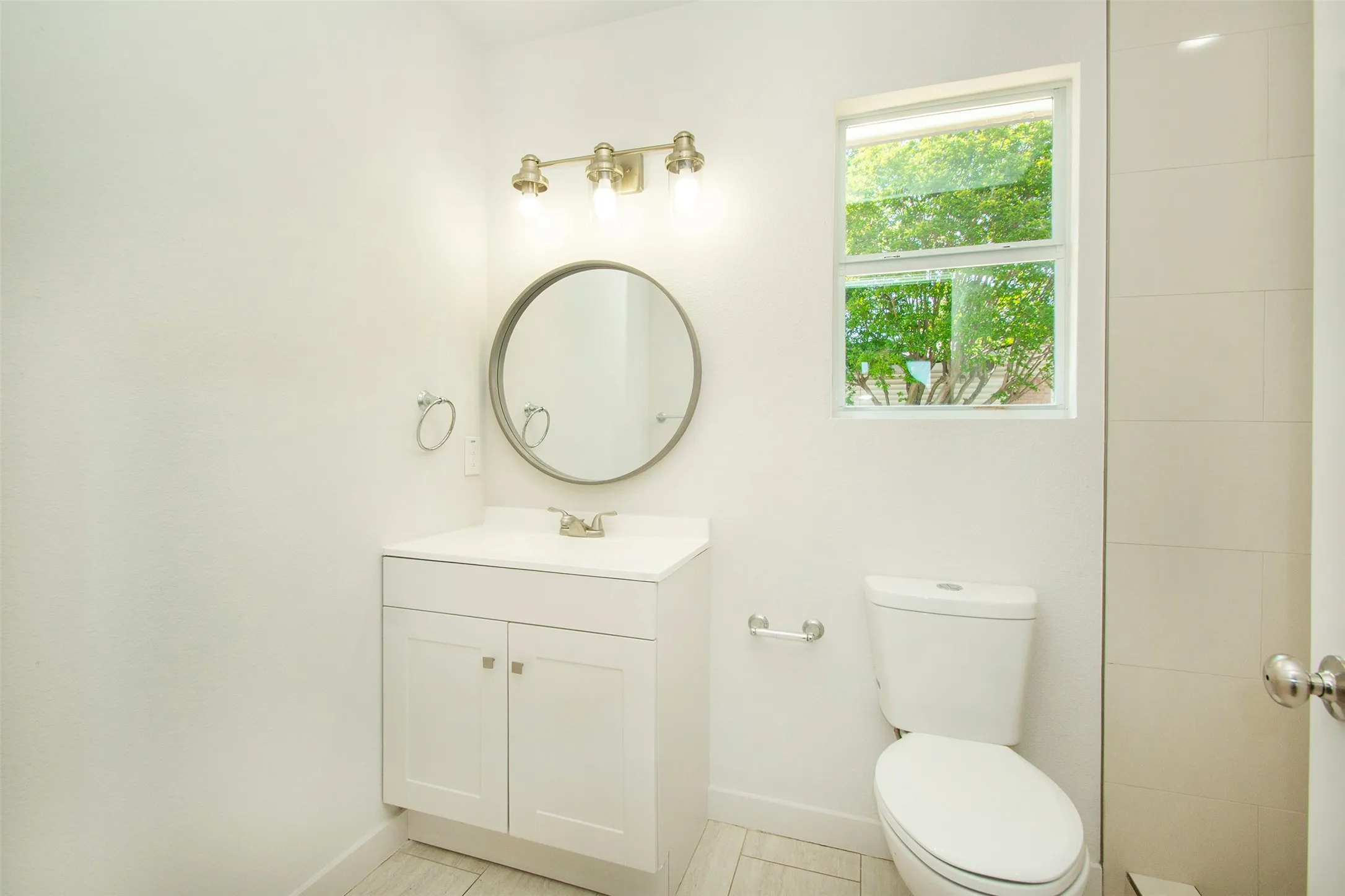 Bathroom with vanity, toilet, and tile flooring