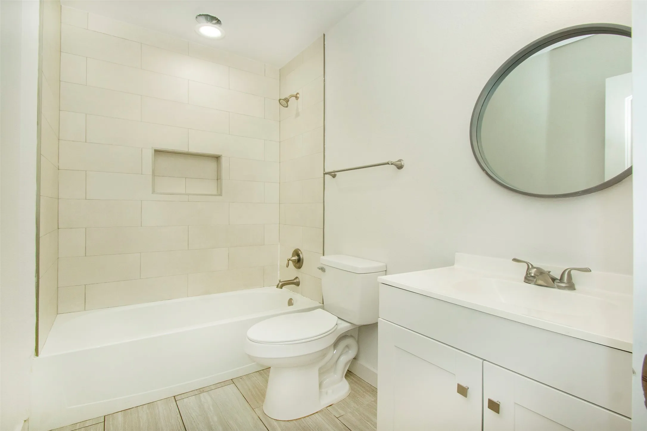 Full bathroom featuring tiled shower / bath, toilet, and large vanity