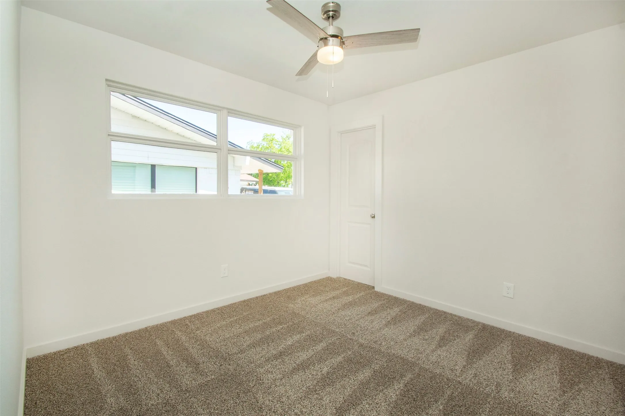 Bedroom with ceiling fan and carpet