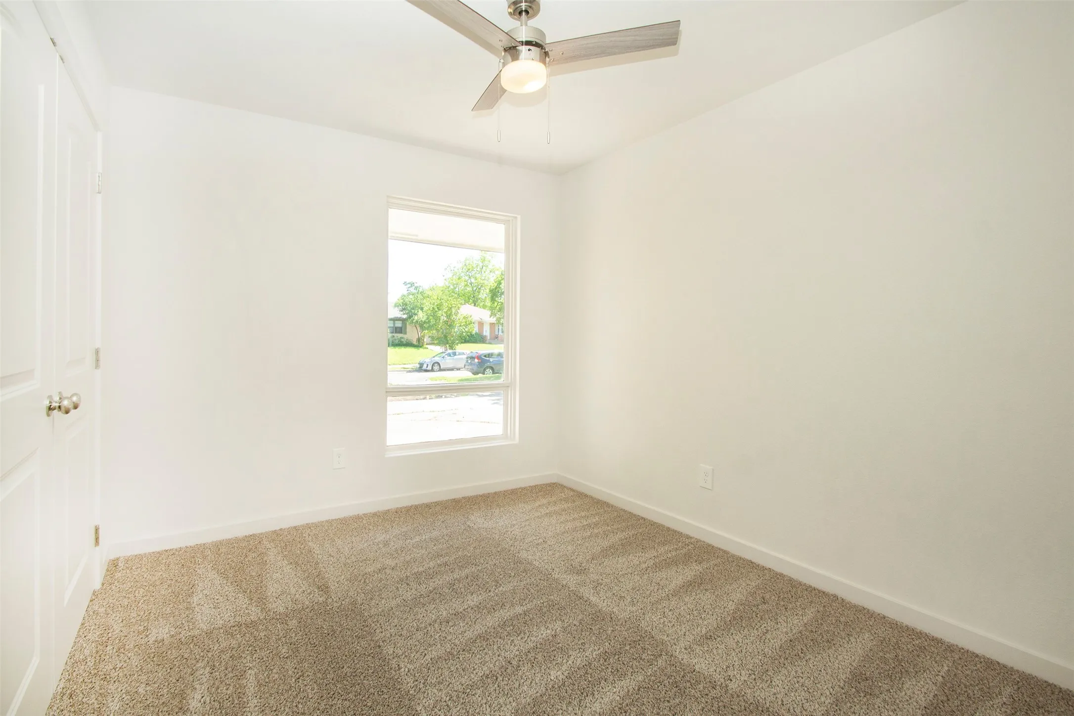 Bedroom featuring ceiling fan and carpet