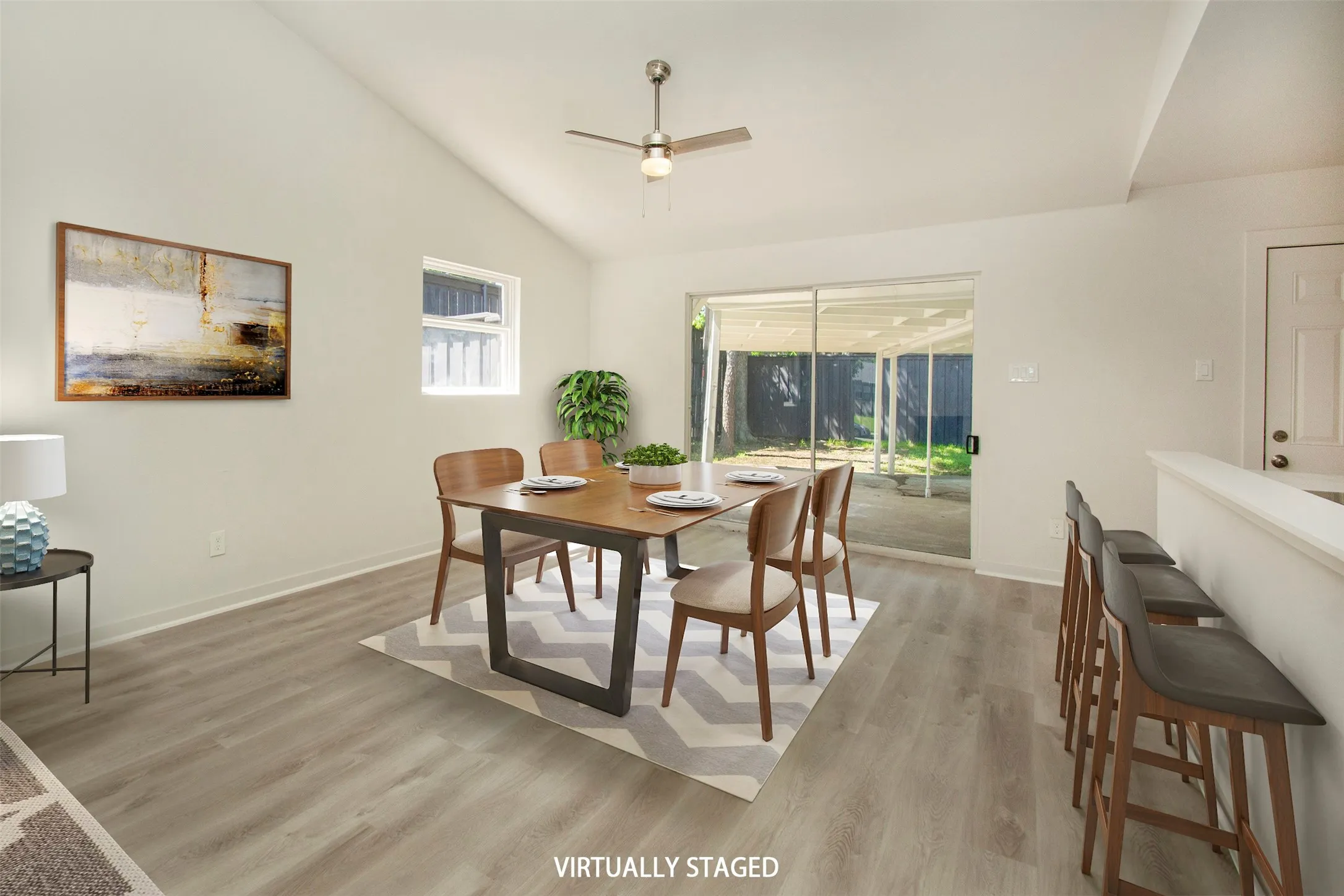 Virtual Staging Dining room with high vaulted ceiling, light hardwood / wood-style flooring, and ceiling fan