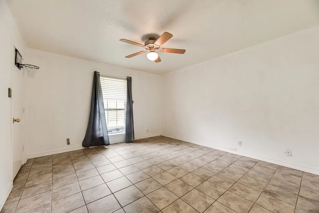 Room featuring neutral ceramic tile flooring and white painted walls