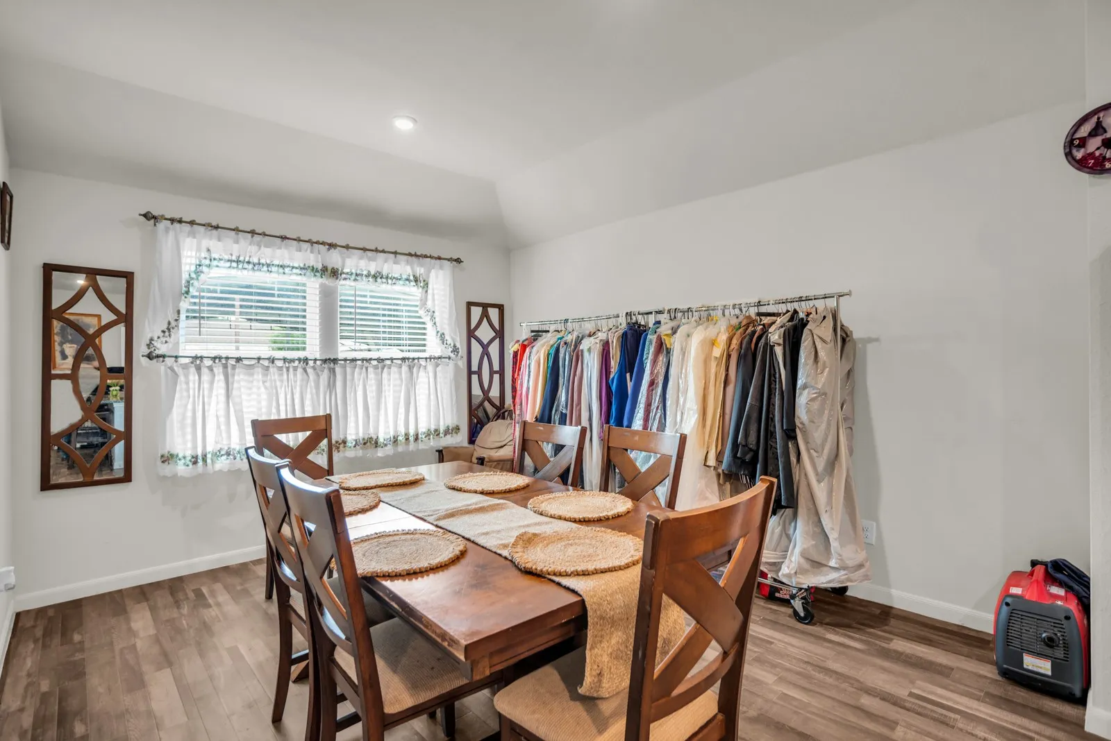 Spacious room with wood-finish flooring, vaulted ceiling, and recessed lighting