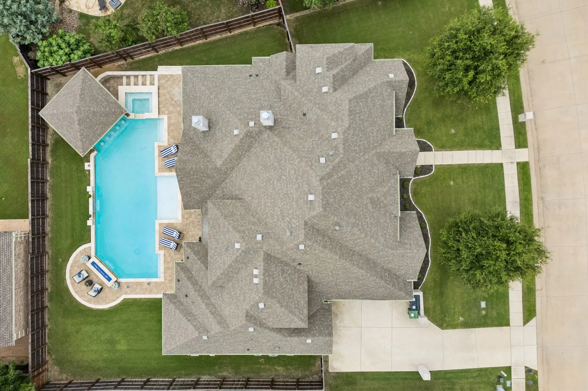 Who can resist this ultimate playground in back. A 50 ft length pool!  Pool comes with a built in basketball goal, firepit, swim up bar with stool, sunken covered outdoor kitchen complete with built in pellet grill, bar sink, outdoor refrigerator and more bar stools in covered area.