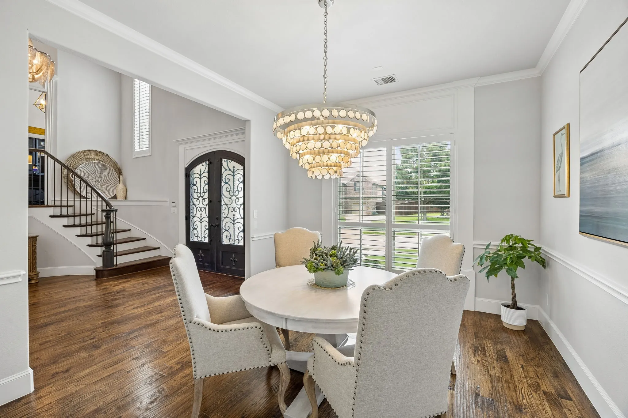 Formal Dining is open from Foyer and leads directly to a Butlers bar and to the Kitchen.  Crown Moldings, extended baseboards and Designer Chandelier