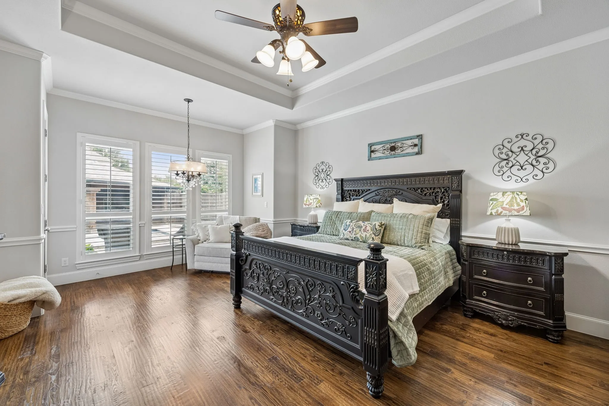 Downstairs Primary Bedroom with sitting area and backyard access.  Room is set at back of home with beautiful view of the pool.  A Private Retreat and Ensuite Bath with dual closets.