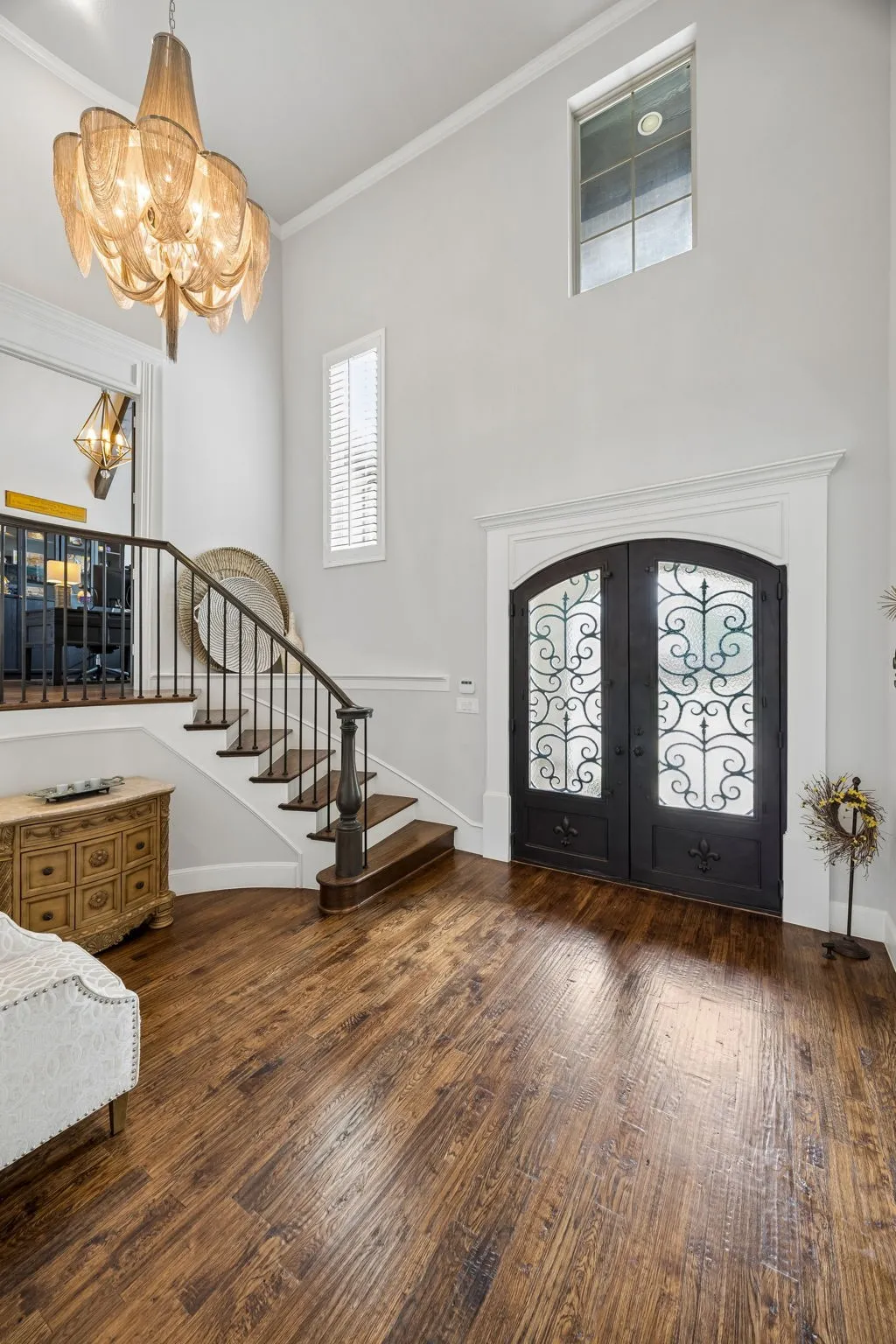 Soaring two story entry with designer chandelier, opens to Formal Dining and Family Room.  Half Way up the stairs is the dedicated Study .  Plantation Shutters throughout this home