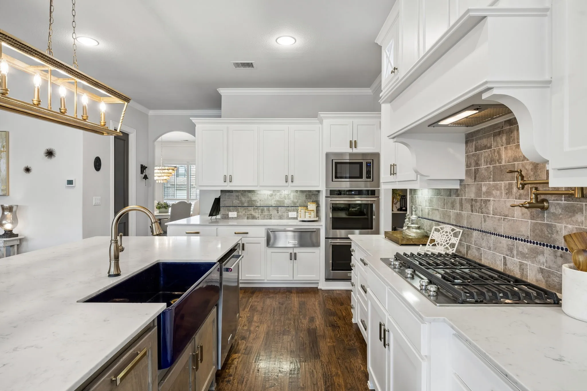Double size Farmhouse Sink, counter height island , designer light and seating for 4 at the island.