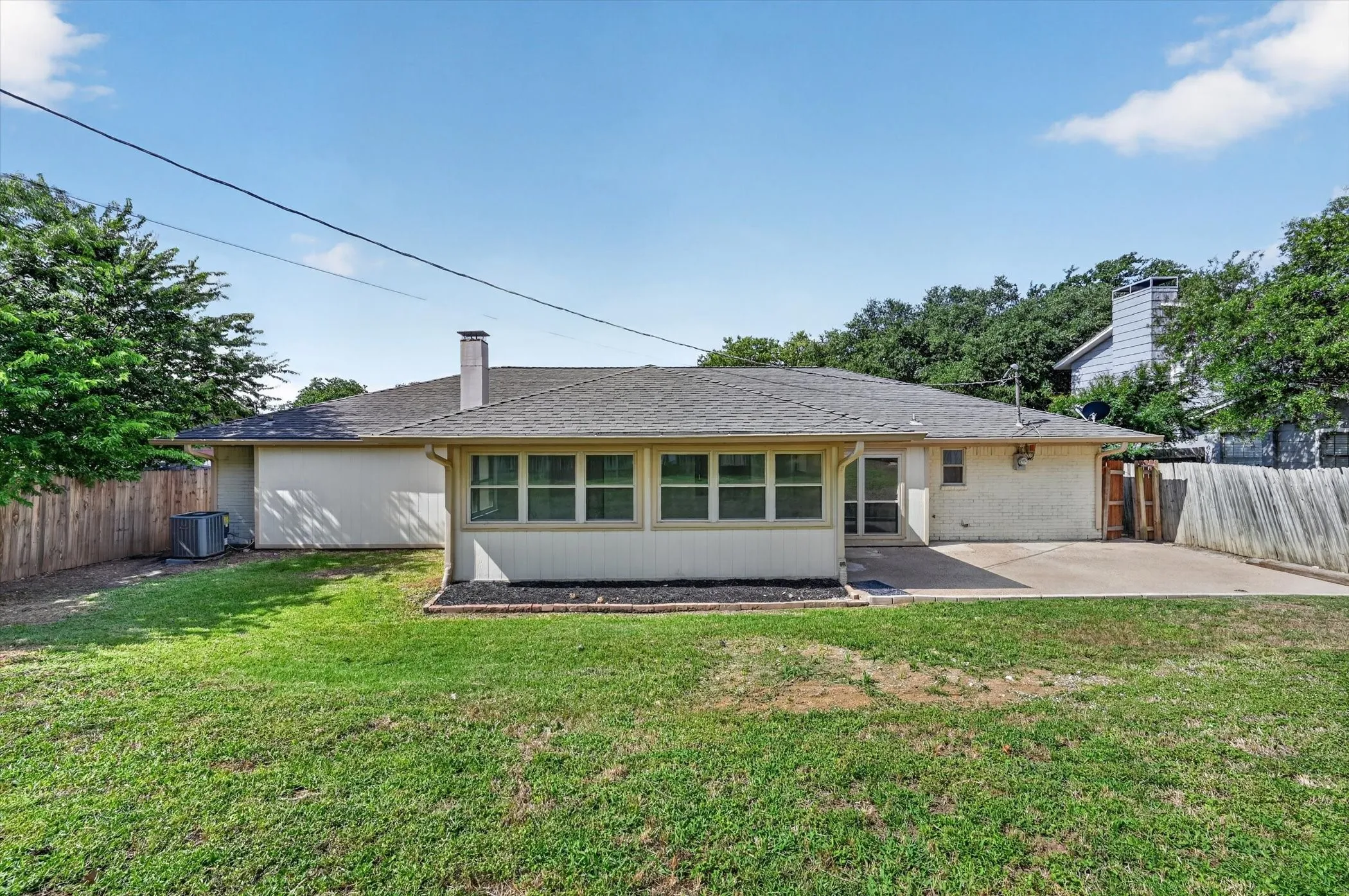 Expansive rear lawn with a full privacy fence