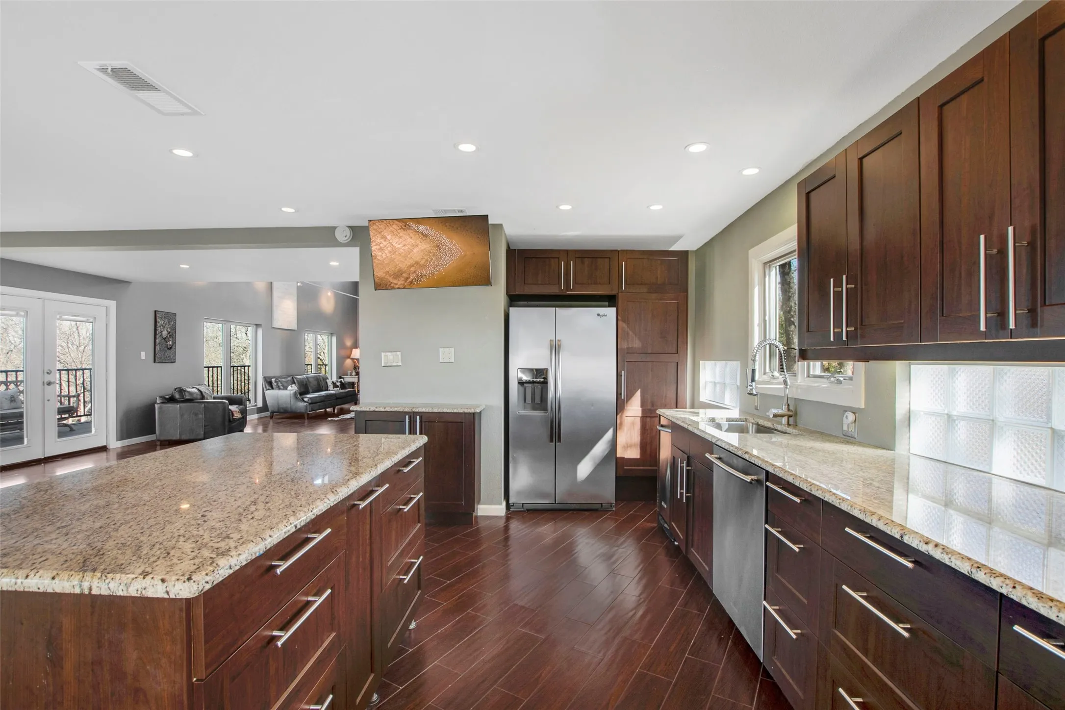 Kitchen featuring rich wood cabinetry, stainless steel appliances, and light-toned countertop surfaces