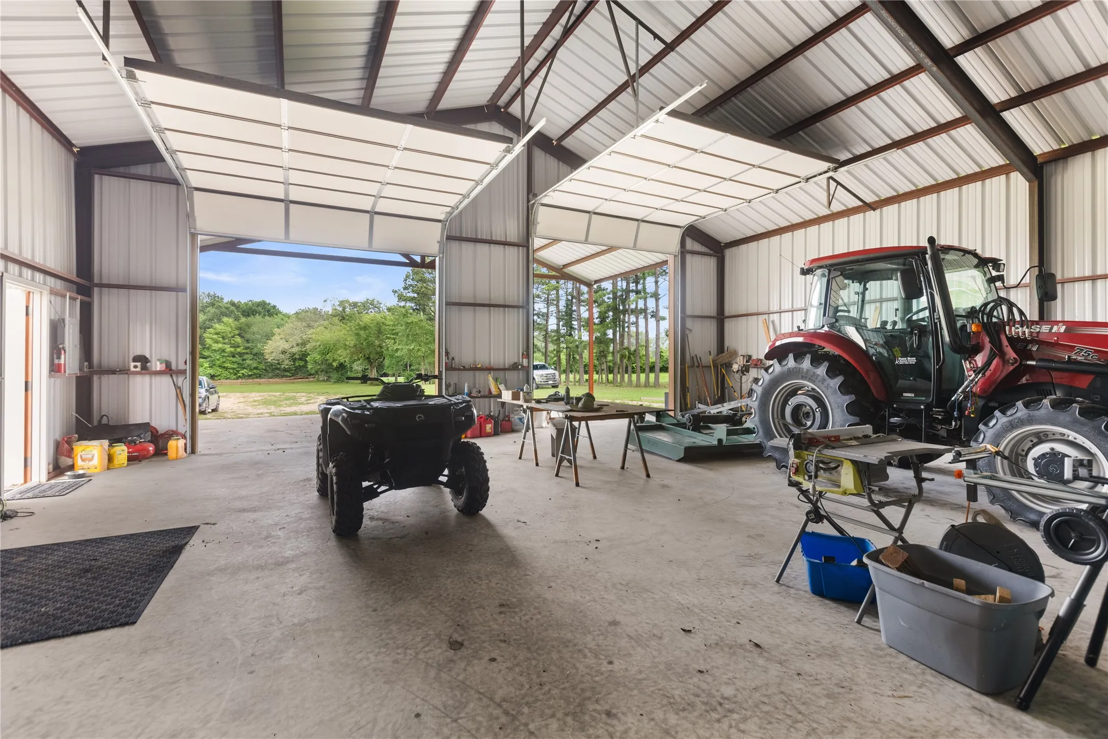Spacious metal-sided outbuilding featuring a concrete floor and exposed steel frame construction