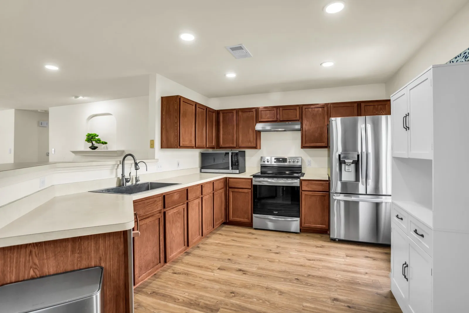 Kitchen featuring wood-finish flooring, recessed lighting, and a stainless steel appliance package