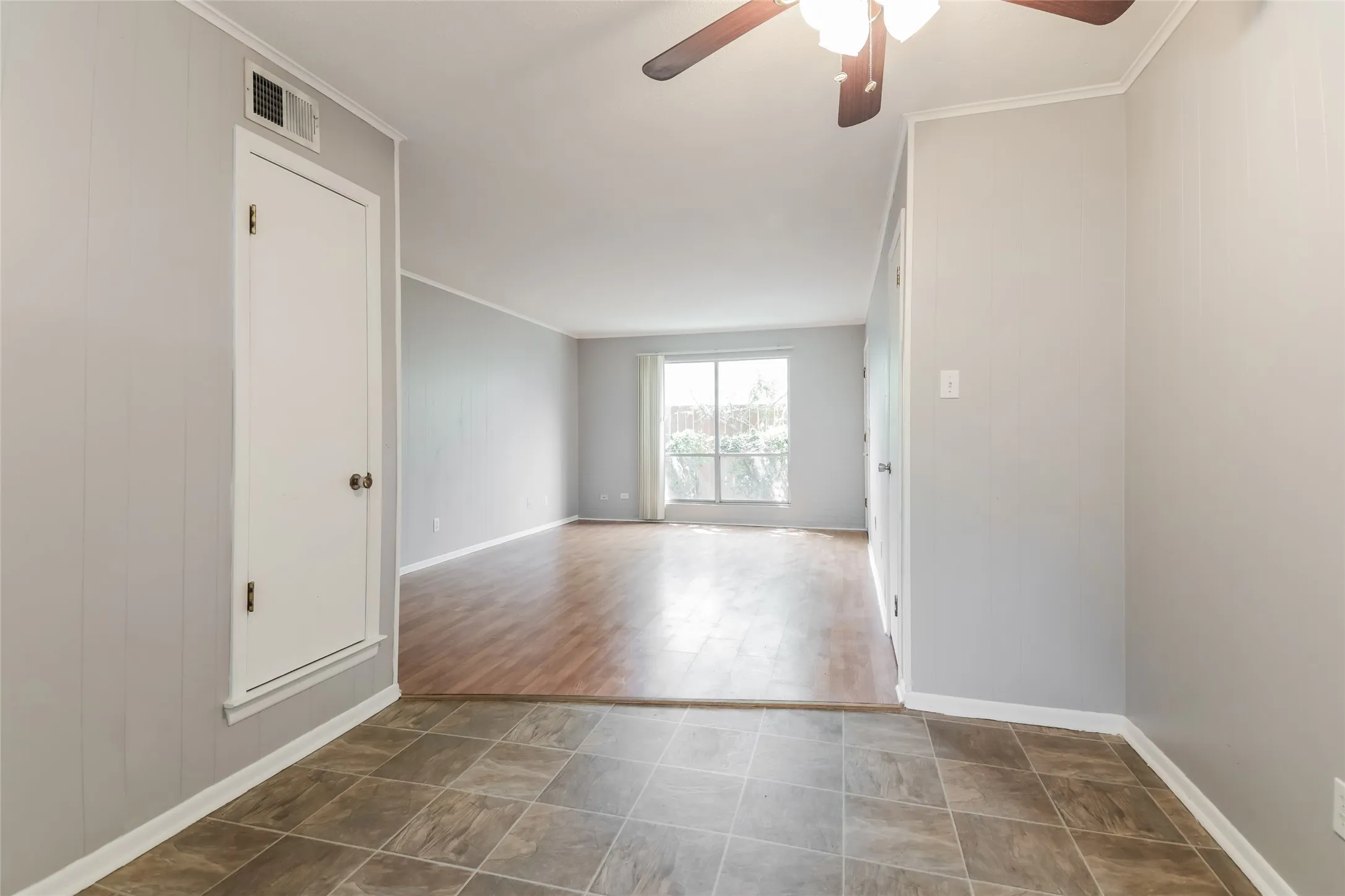 Interior space featuring ceramic tile flooring, light gray walls, and white baseboards