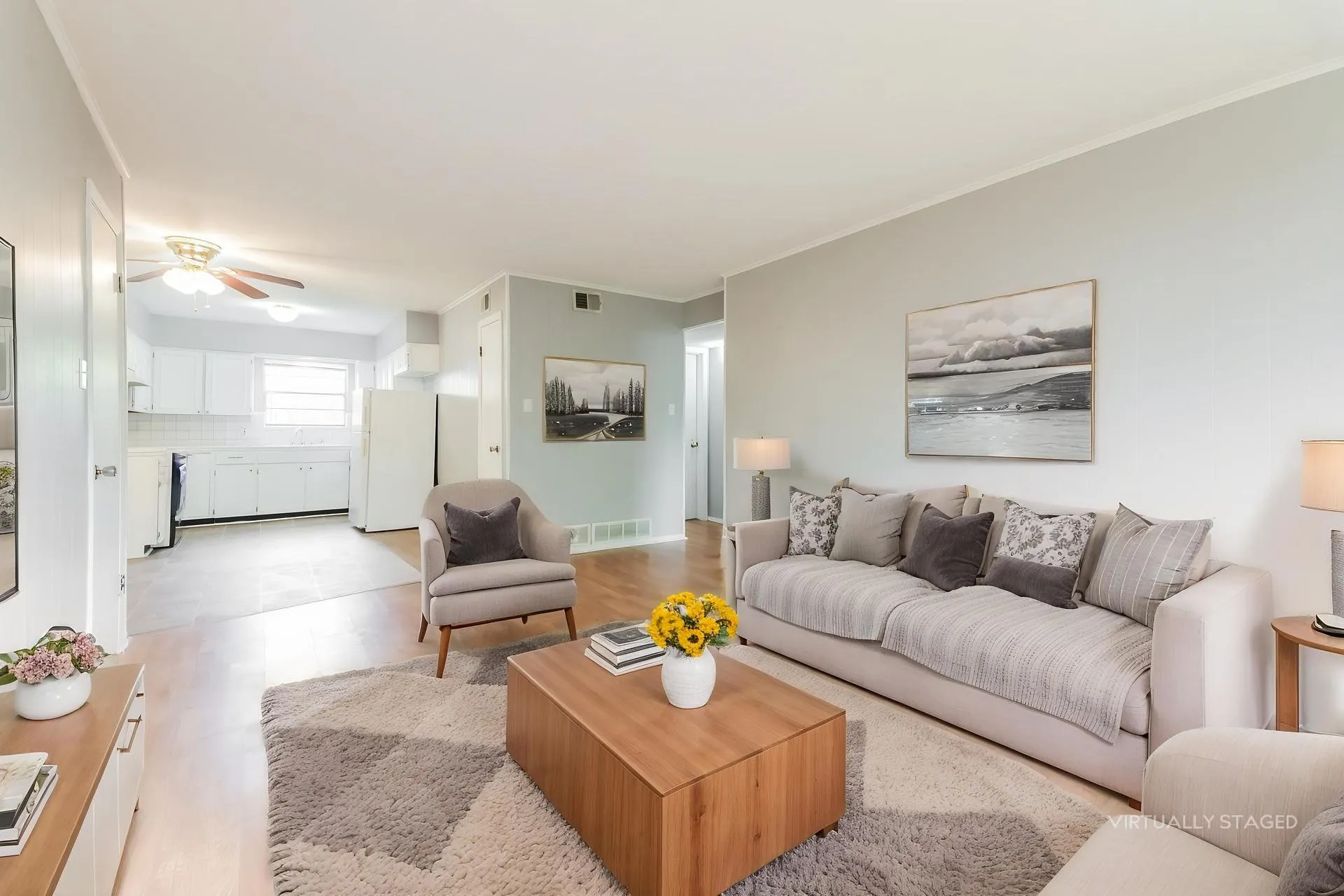Open-concept living area featuring wood-finish flooring, a neutral color palette, and recessed lighting