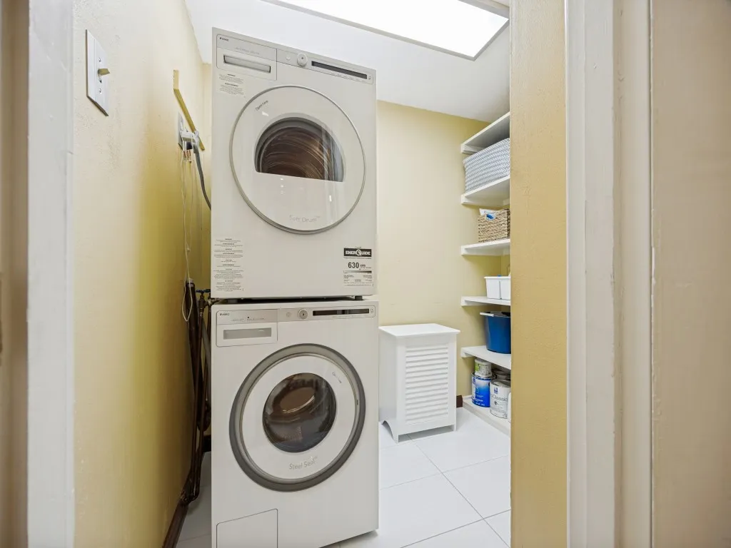 Dedicated laundry room with room for full size stackable or side-by-side units, plus lots of extra storage shelves.