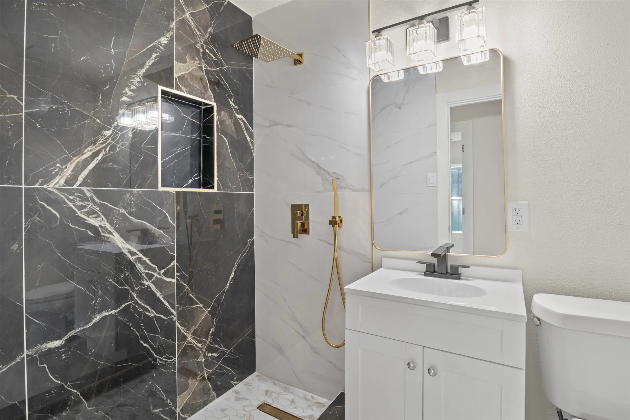Contemporary bathroom featuring a walk-in shower with dark marbled wall tile and a built-in shower niche