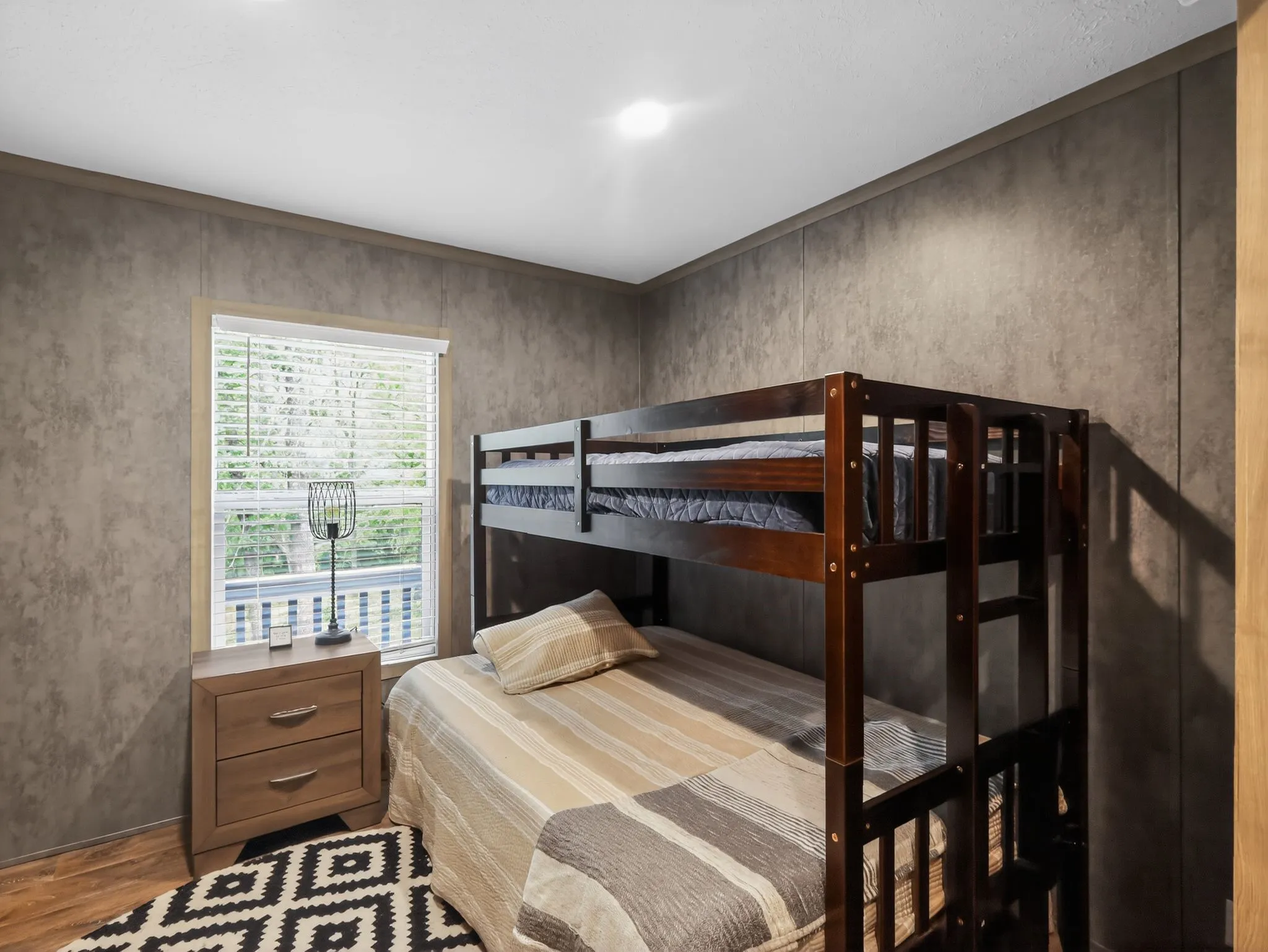 Room with a window, wood-finish flooring, and recessed lighting