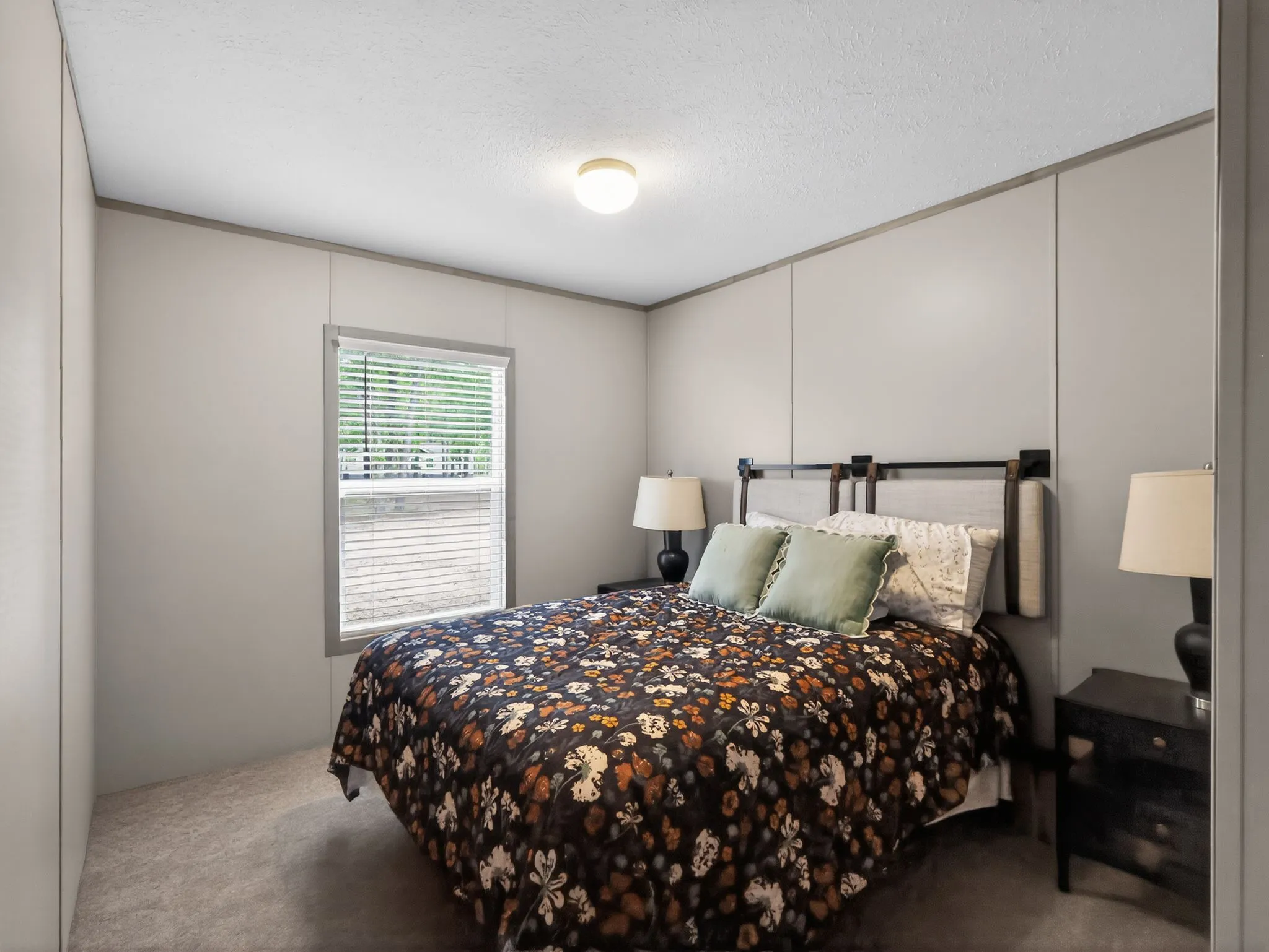 Wall-to-wall carpeting and a single window with blinds