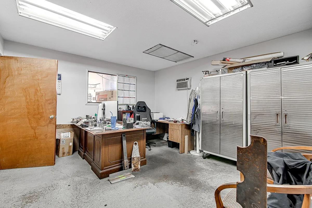 Open-concept room featuring concrete flooring and white painted walls
